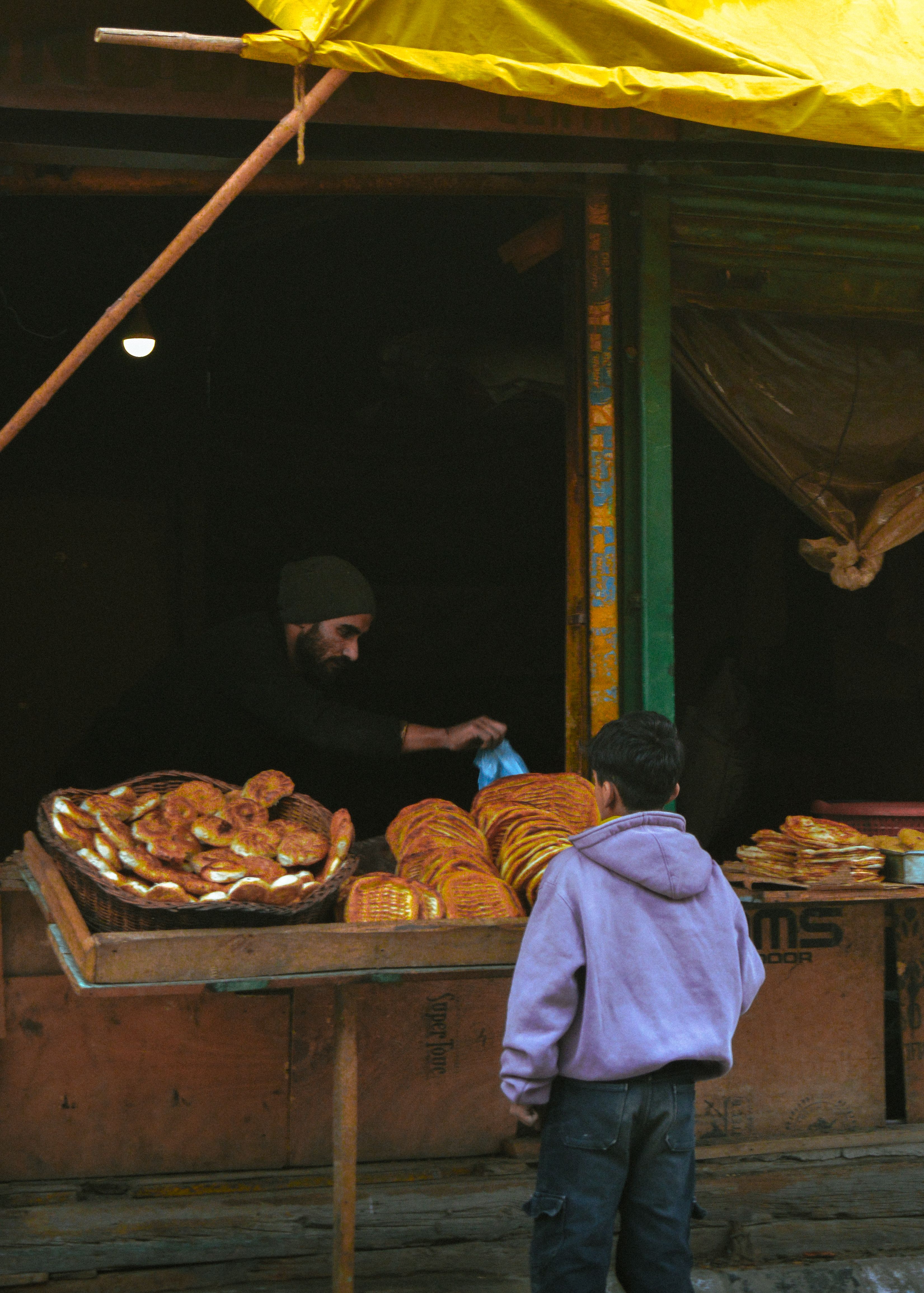 Street Baker Selling Fresh Bread Outdoors · Free Stock Photo