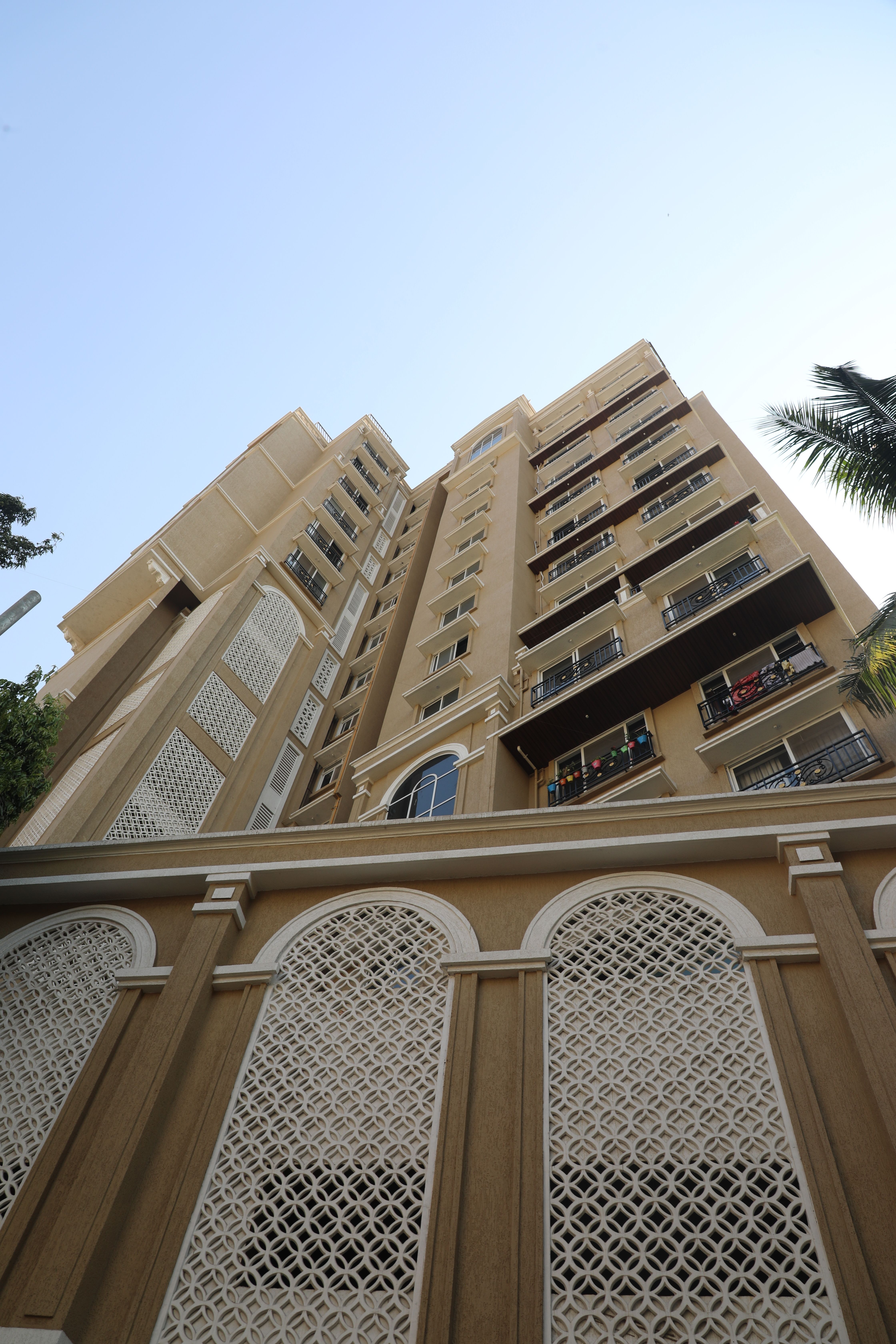 Low angle view of a modern high-rise apartment building against clear sky.