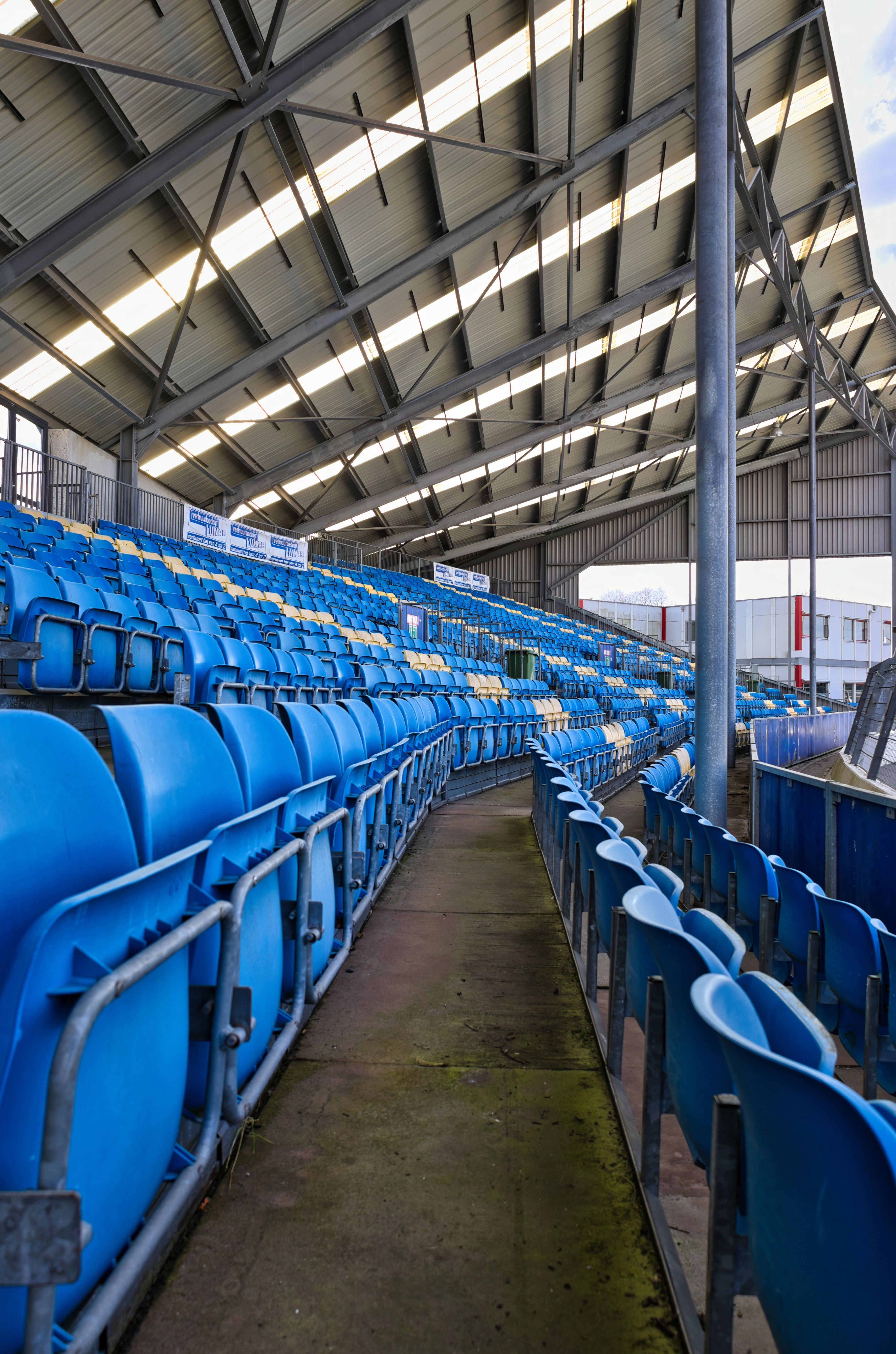 Empty Stadium Seating Under Metal Canopy · Free Stock Photo