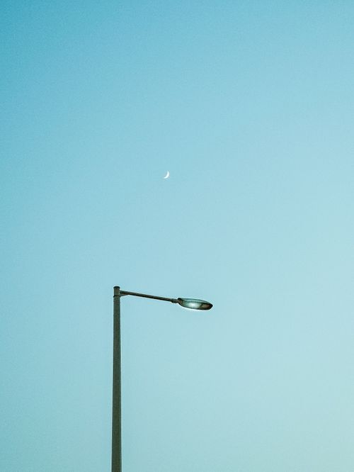 Free A streetlight against a clear sky with a crescent moon, captured in Abu Dhabi. Stock Photo
