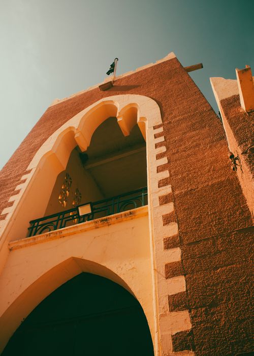 Free A captivating view of a Mediterranean-style architectural facade under a vibrant sky. Stock Photo