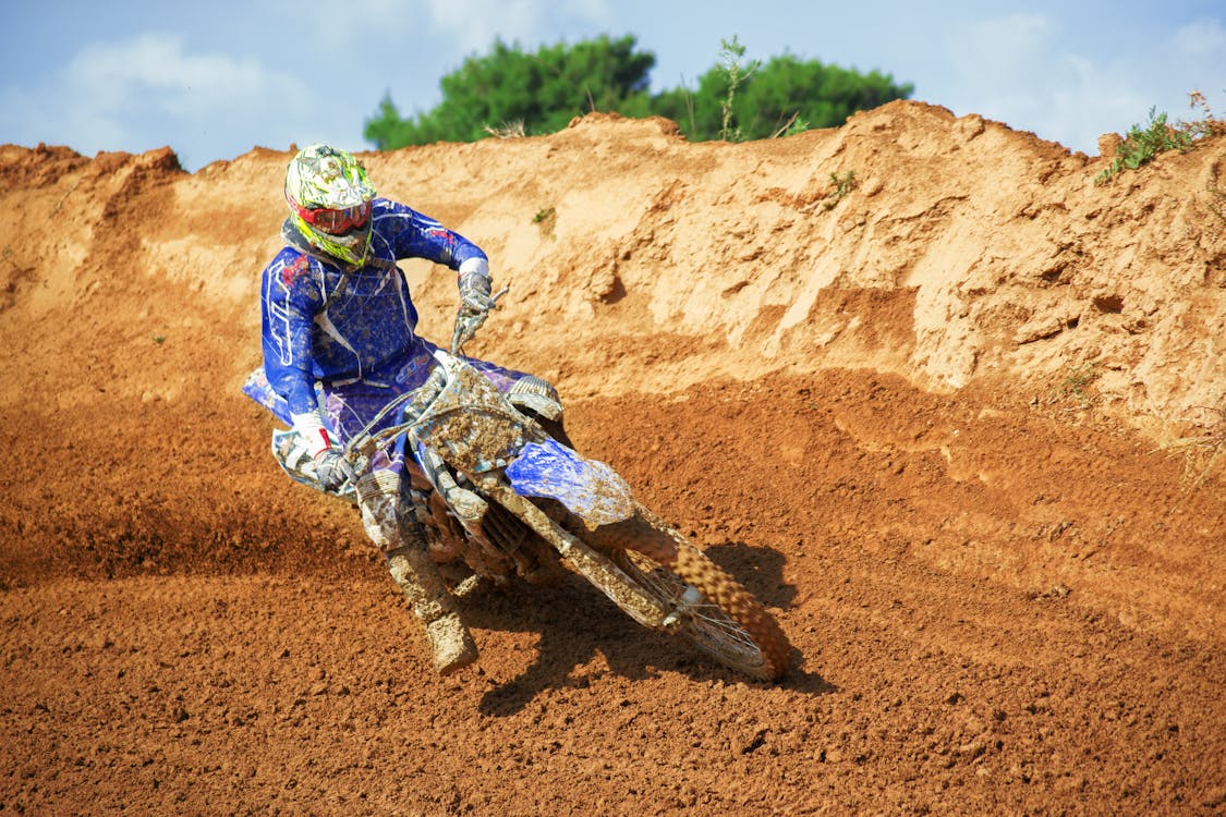 Man Riding Enduro Motocross on Sand Dune