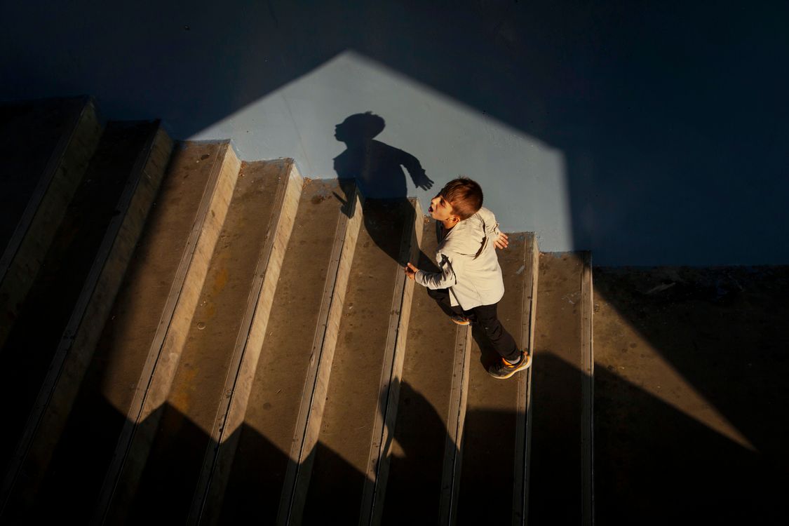 Boy Shadow Effect Boy Climbing Stairs in Dramatic Shadow Light ยท Free Stock Photo