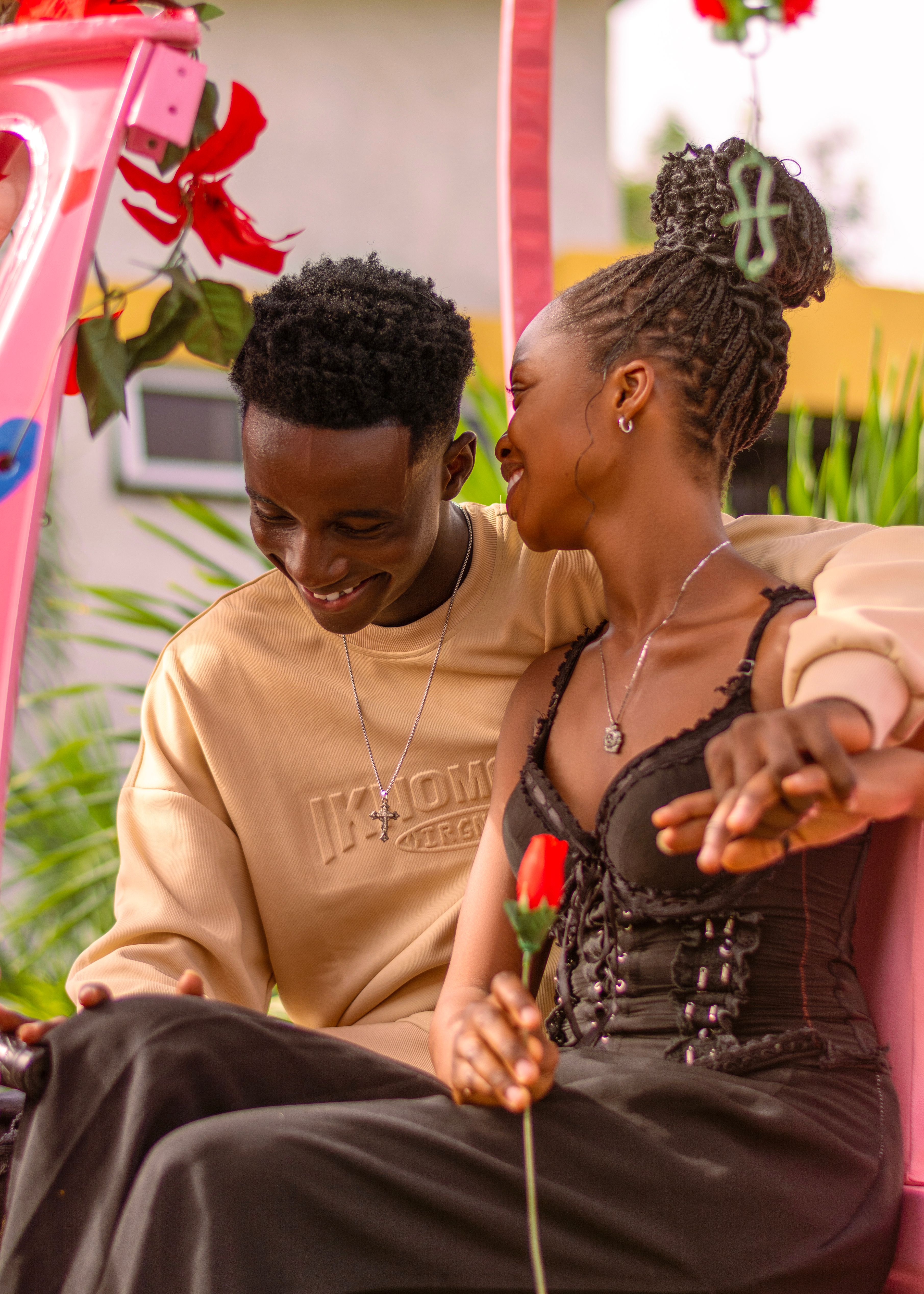 A joyful couple enjoying a romantic moment outdoors with vibrant colors and heartfelt expressions.