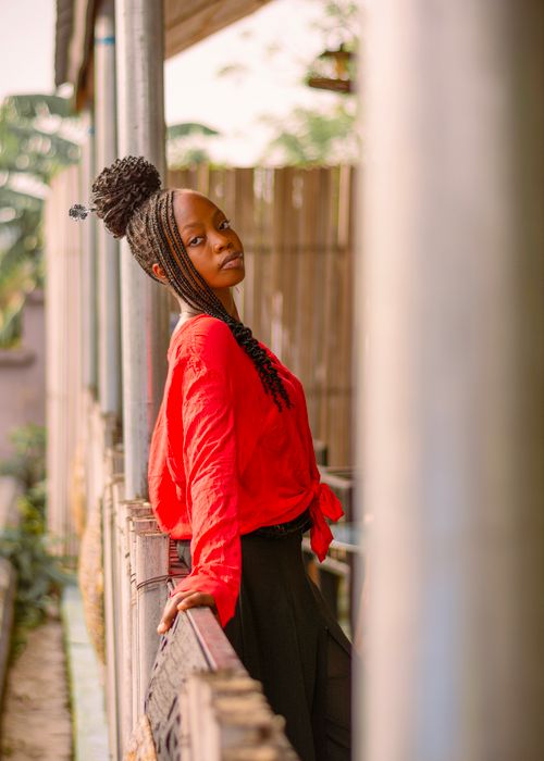 Free Stylish woman in a red top poses gracefully outdoors, exuding confidence and elegance. Stock Photo
