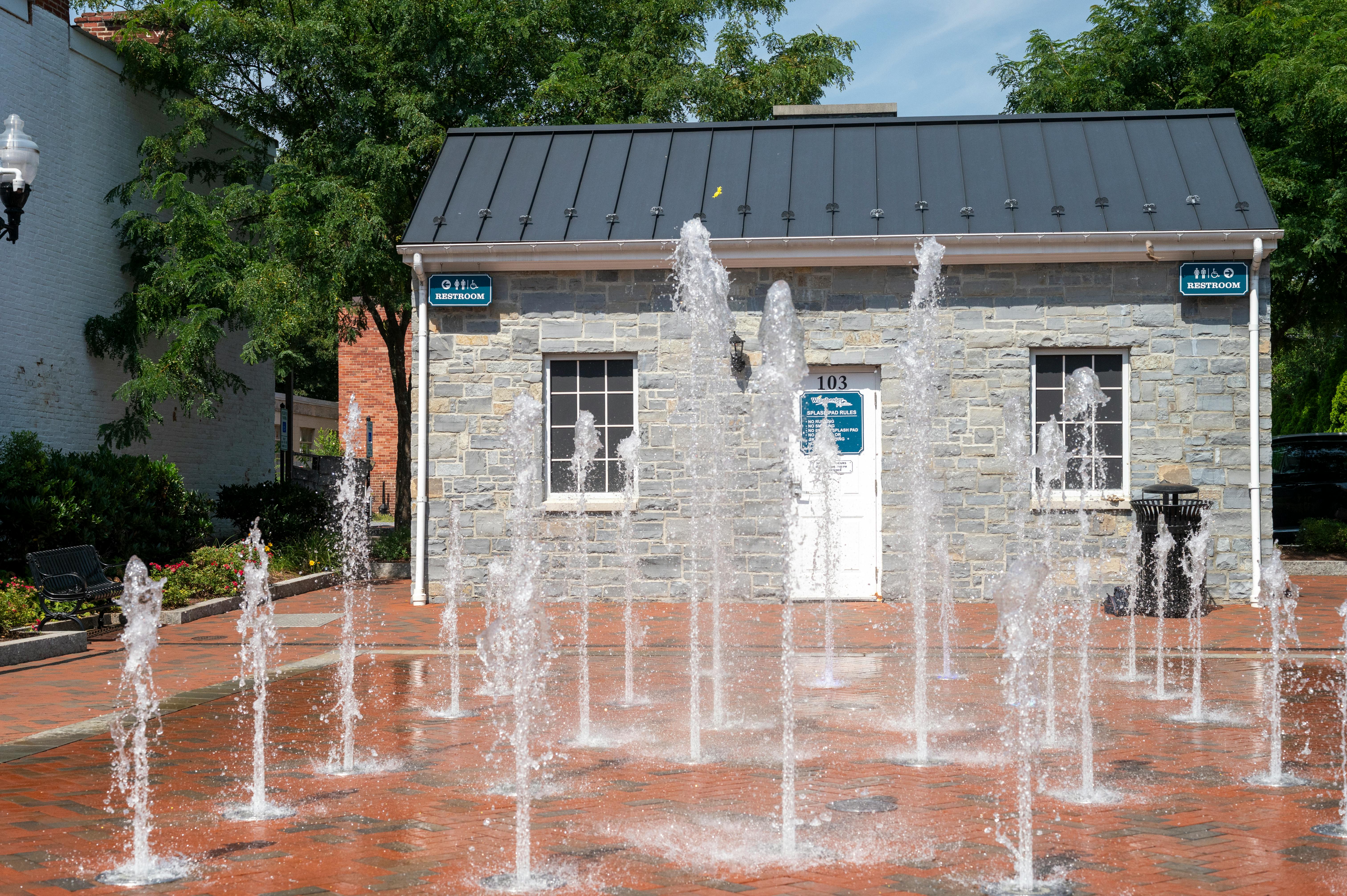 Charming interactive fountain in a Winchester city park, ideal for summertime fun and relaxation.