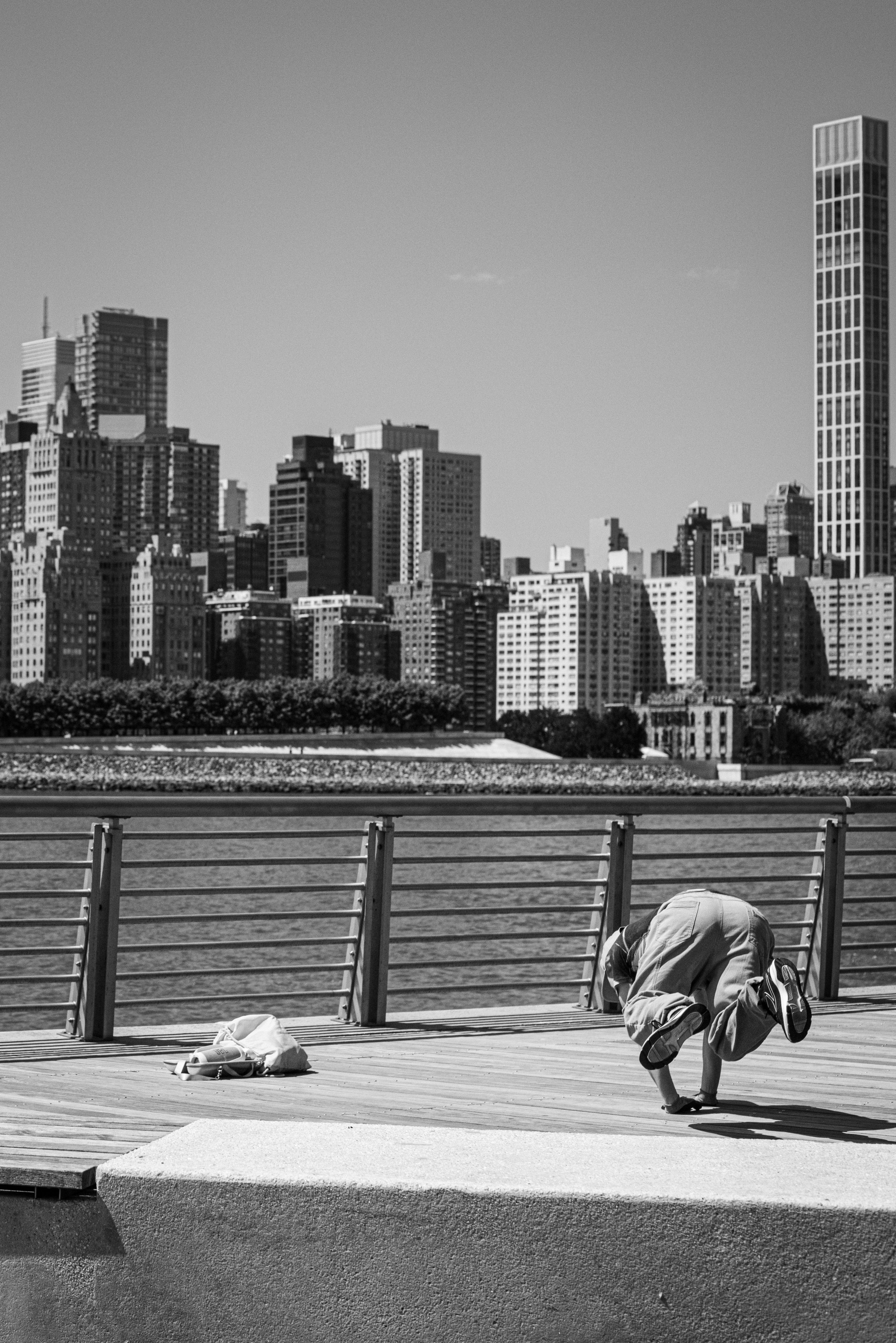 Dynamic breakdancer showcases moves with the New York City skyline in the backdrop.