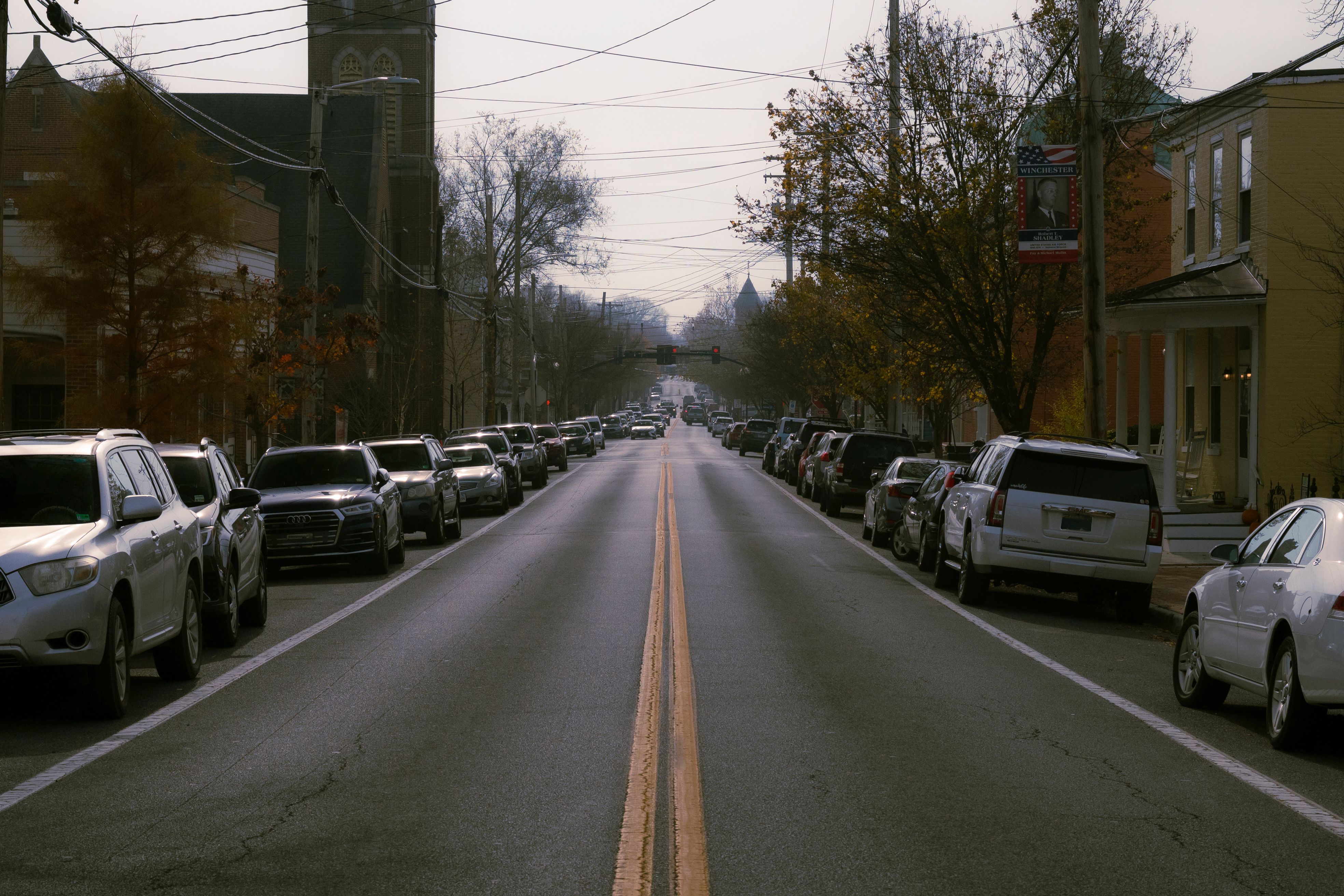 Quiet Residential Street Lined with Parked Cars · Free Stock Photo