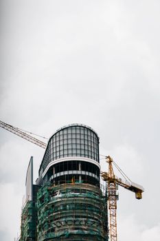 Skyscraper construction in Nairobi, Kenya, featuring cranes and modern architectural design.