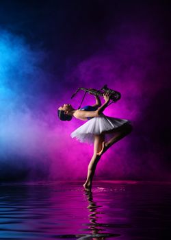 Elegant ballerina in a white tutu plays saxophone on one leg, surrounded by vibrant colored smoke.