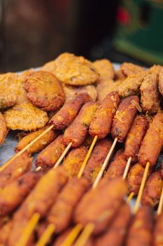 Mouth-watering Bangladeshi street food skewers and patties ready for serving, showcasing vibrant flavors.