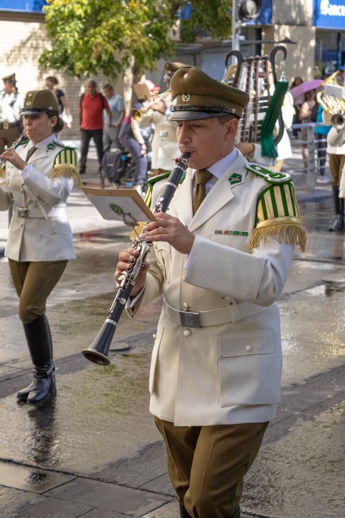 Free Military band performing during an outdoor parade in Santiago, Chile with uniformed musicians. Stock Photo