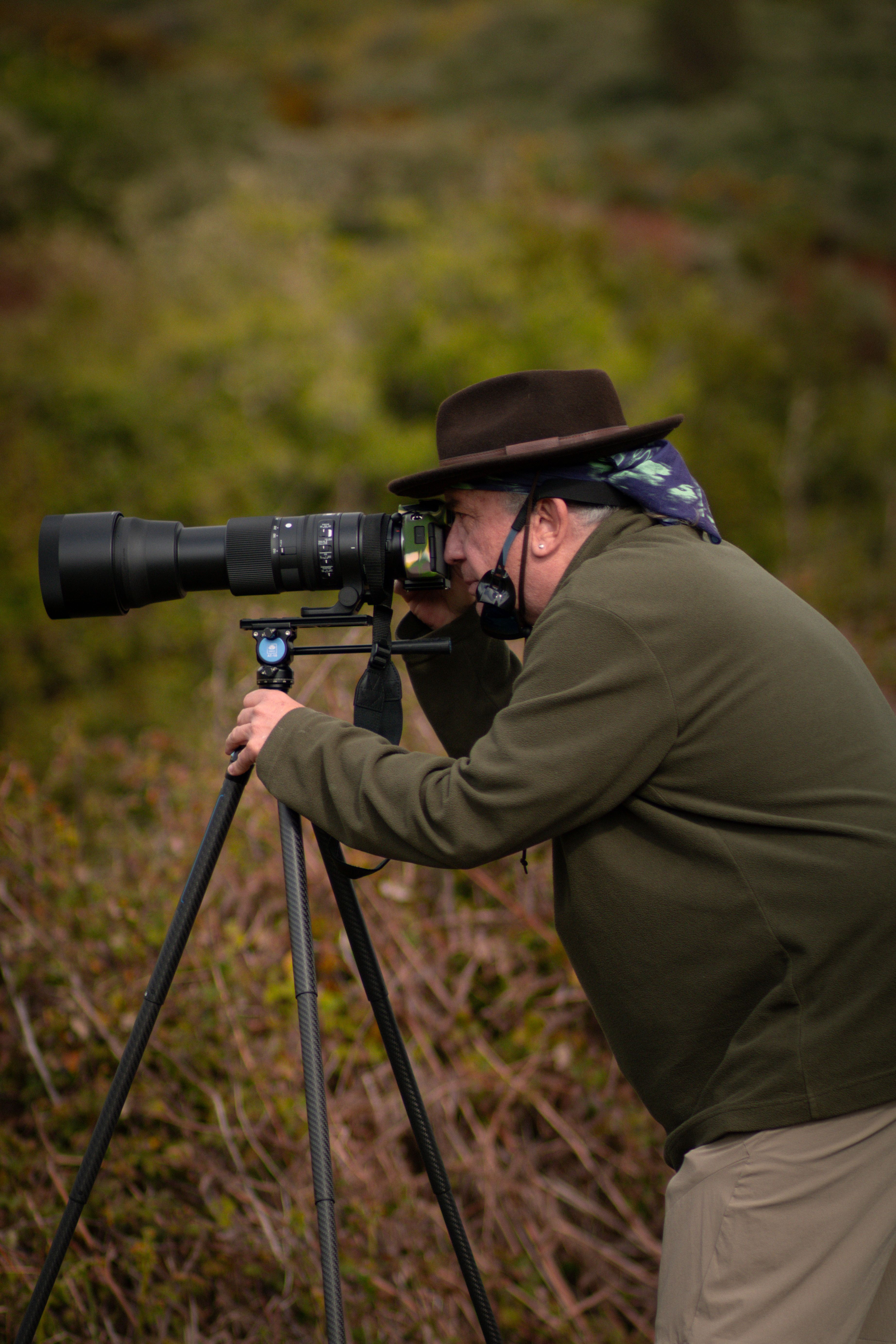 A wildlife photographer captures nature using a long lens camera in Erjos, Spain.