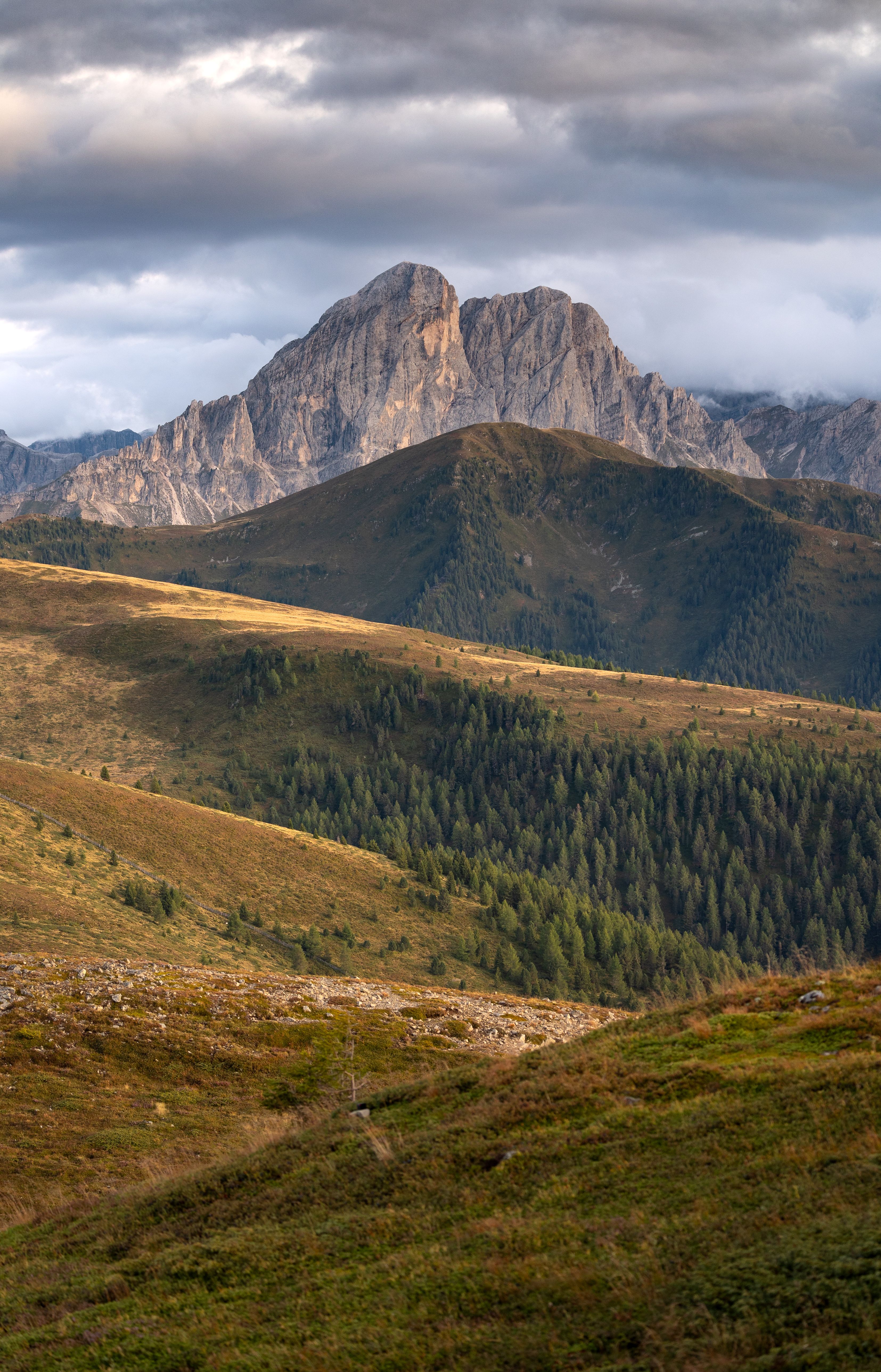 Breathtaking view of the Dolomites in Italy with a sunset glow over the landscape.