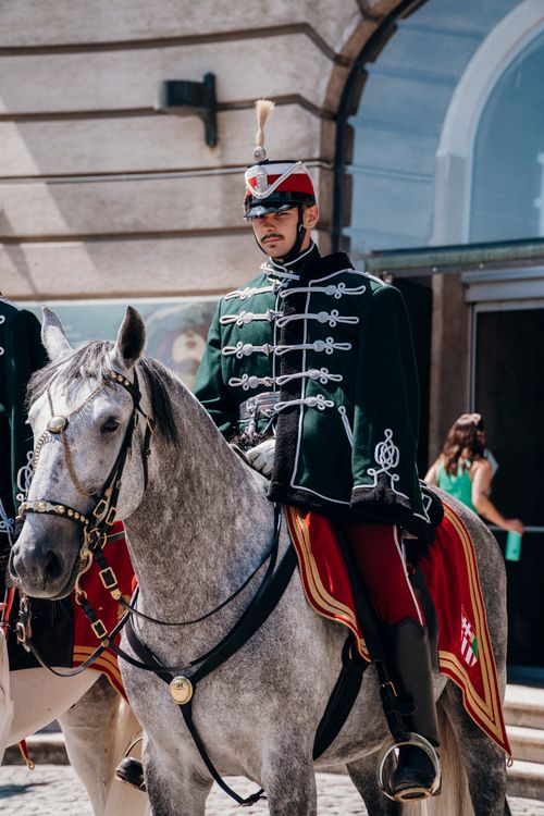 Free A traditional Hungarian hussar dressed in ceremonial uniform on horseback in Budapest, Hungary. Stock Photo