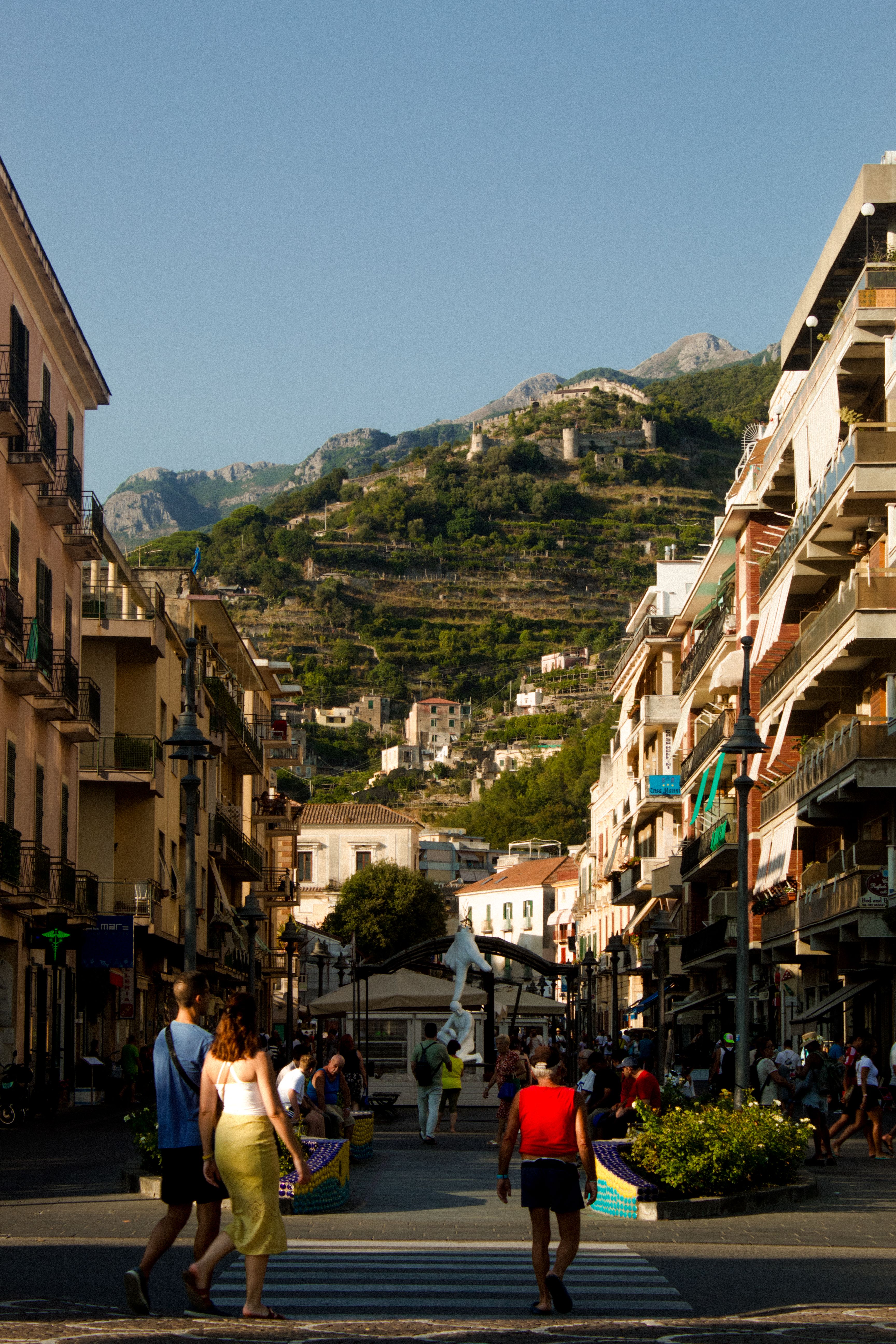 Charming street scene in Maiori, Campania with vibrant summer atmosphere and picturesque hillside.