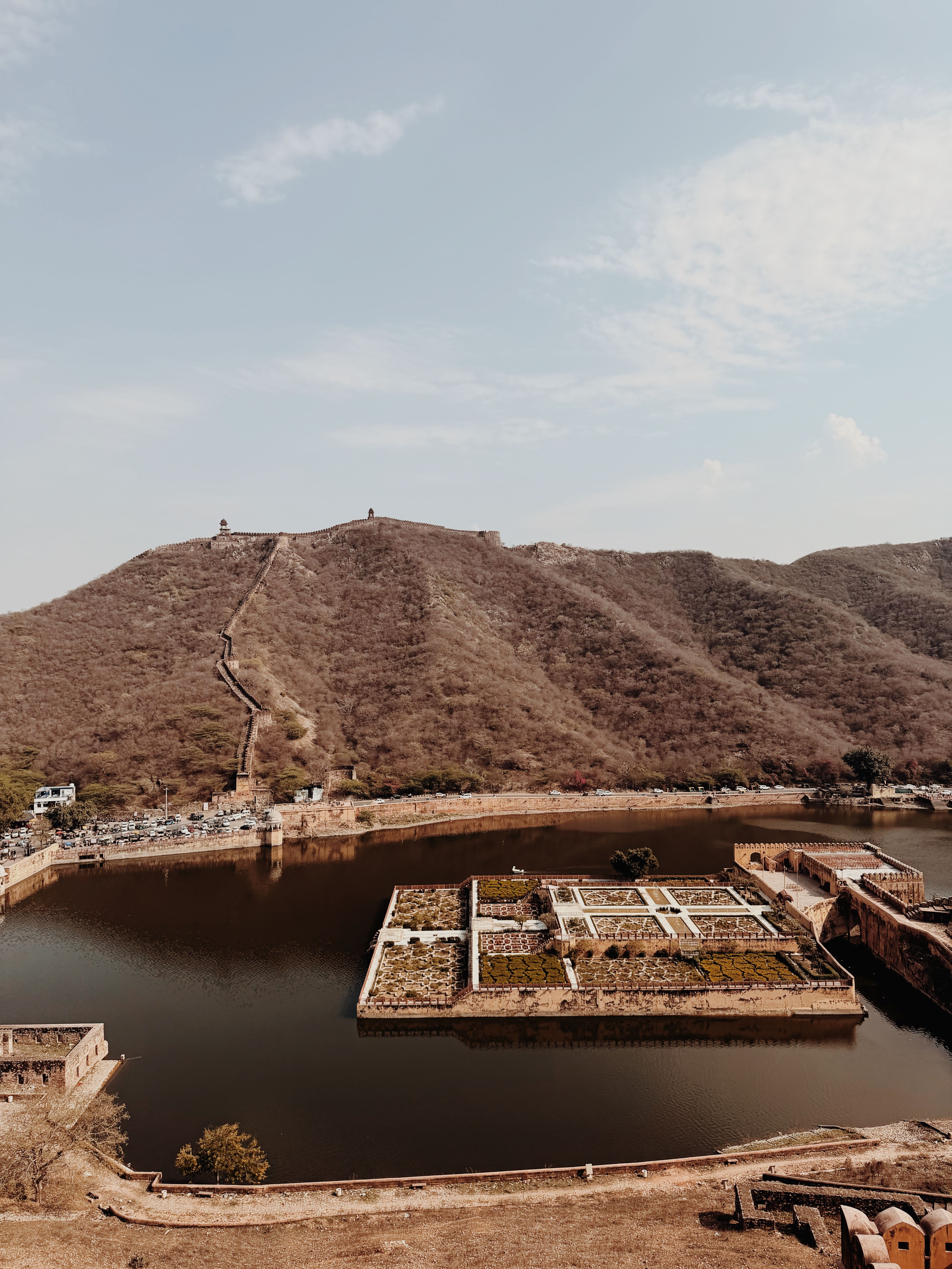 A stunning aerial shot of the Amer Fort and Maota Lake in Jaipur, showcasing historic architecture and scenic beauty.