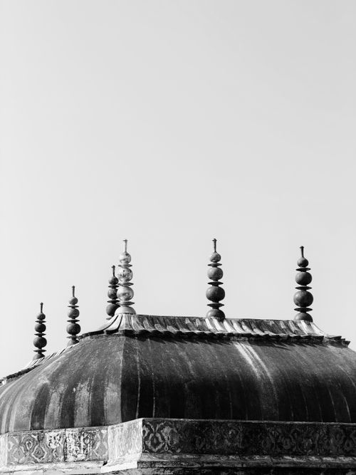 Free A minimalist black and white photograph of a dome with spires against a clear sky, showcasing architectural elements. Stock Photo