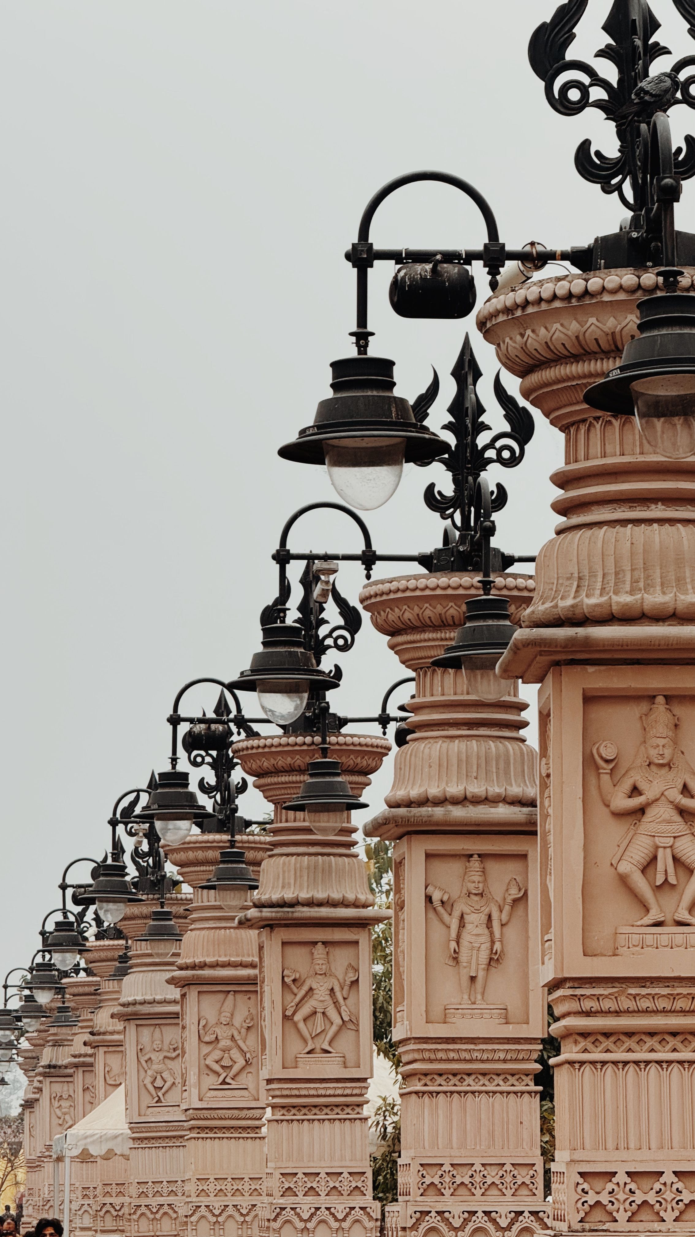 Row of intricately designed street lamps in Ujjain, showcasing traditional architectural elements.