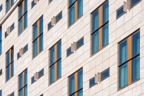 Free High-angle view of a modern building facade with patterned windows and geometric design. Stock Photo