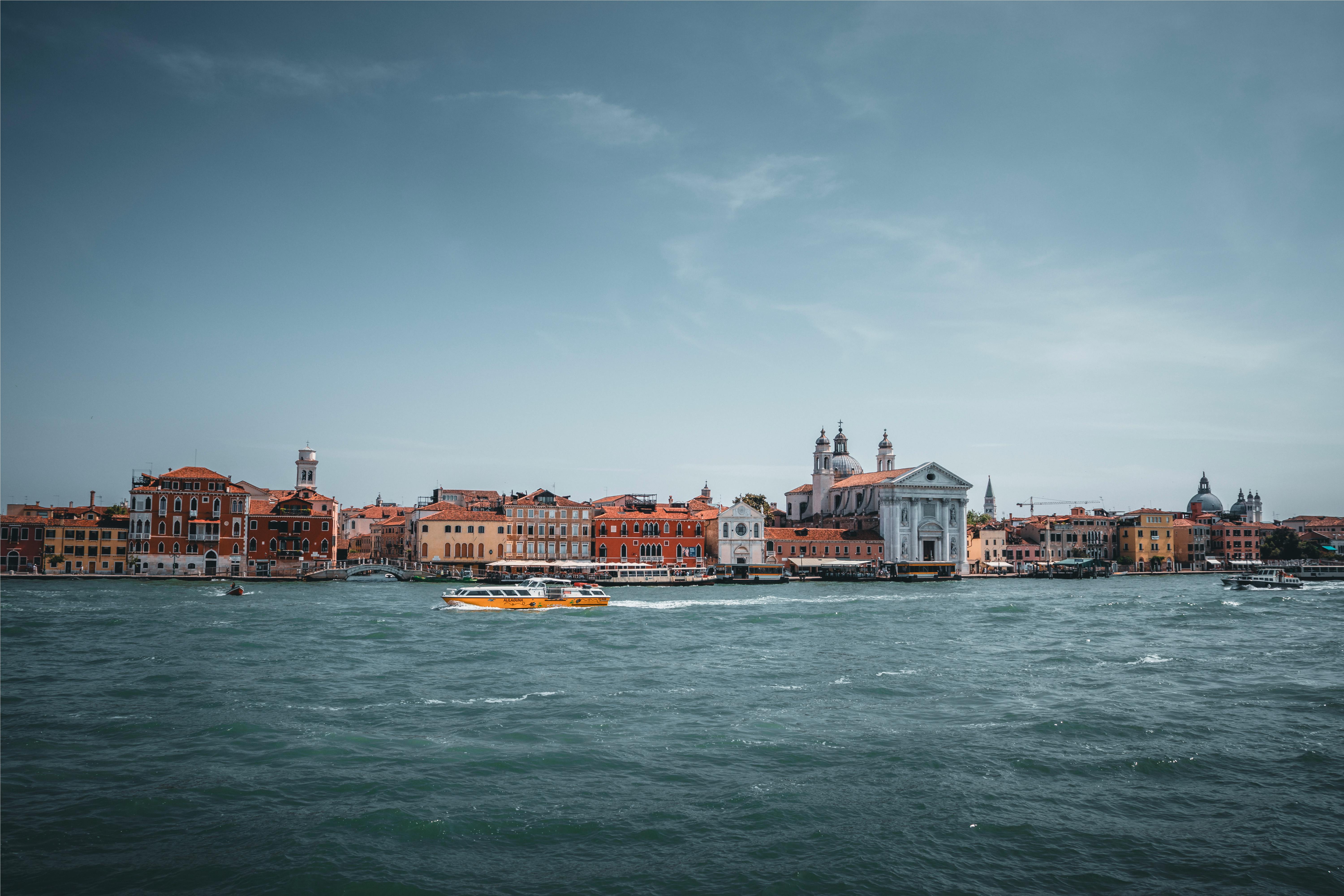 Scenic view of Venice's Grand Canal and Santa Maria del Rosario in Italy with vibrant architecture.