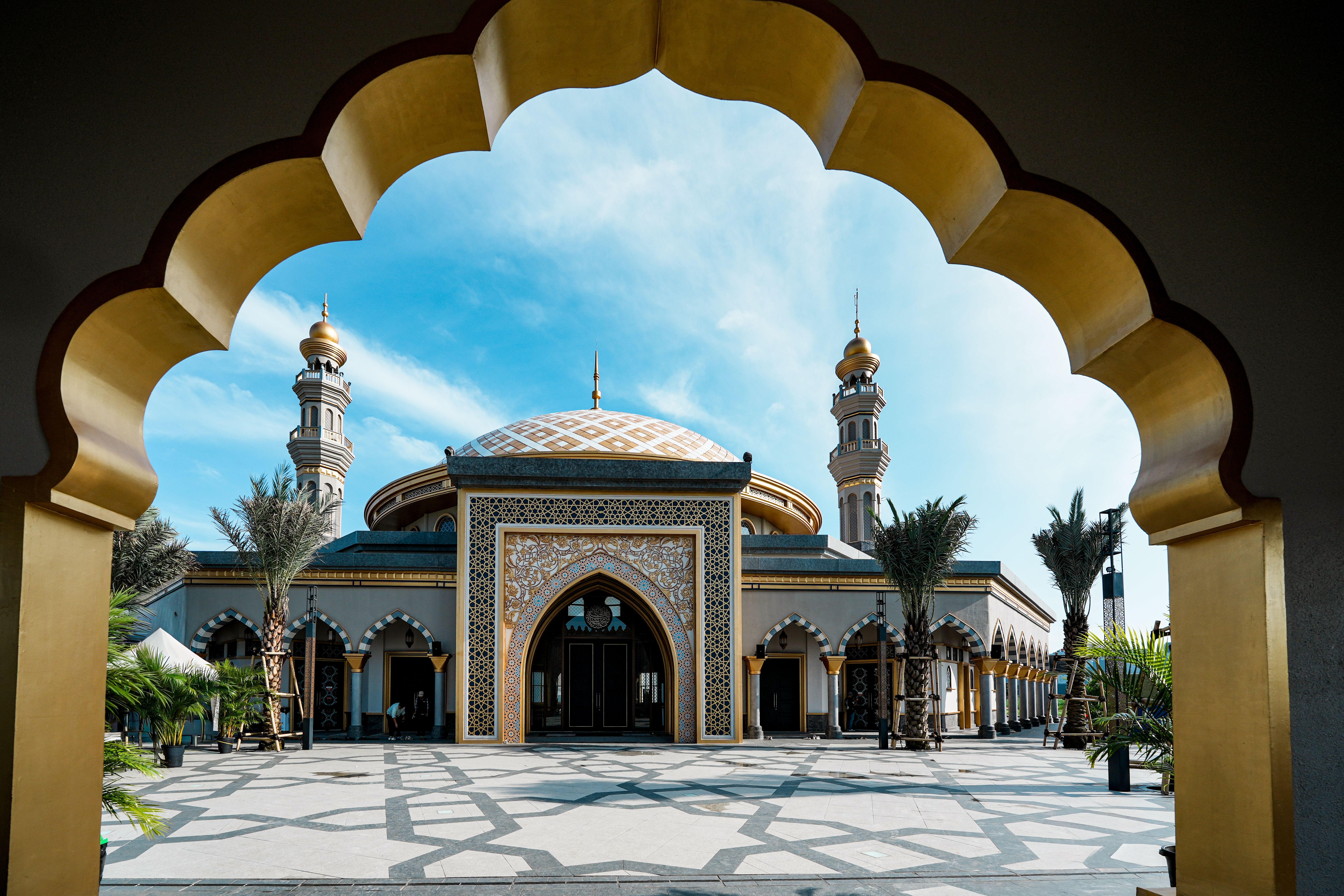 Captivating view of a beautifully designed mosque with blue skies in Jakarta, Indonesia.