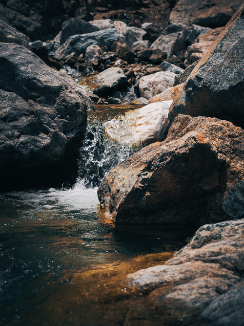 Free A tranquil waterfall cascades over rocks in Khourfakkan, UAE, capturing nature's raw beauty. Stock Photo