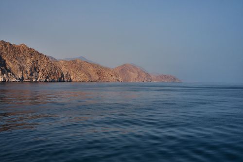 Free Peaceful seascape of Musandam's rugged coastline under a clear sky. Stock Photo