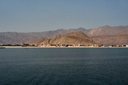 Free Scenic view of Musandam's rugged mountains and serene coastline under a clear sky. Stock Photo