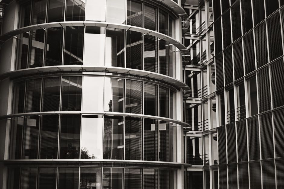 Close-up view of a modern architectural building facade with glass and steel structure in Berlin.