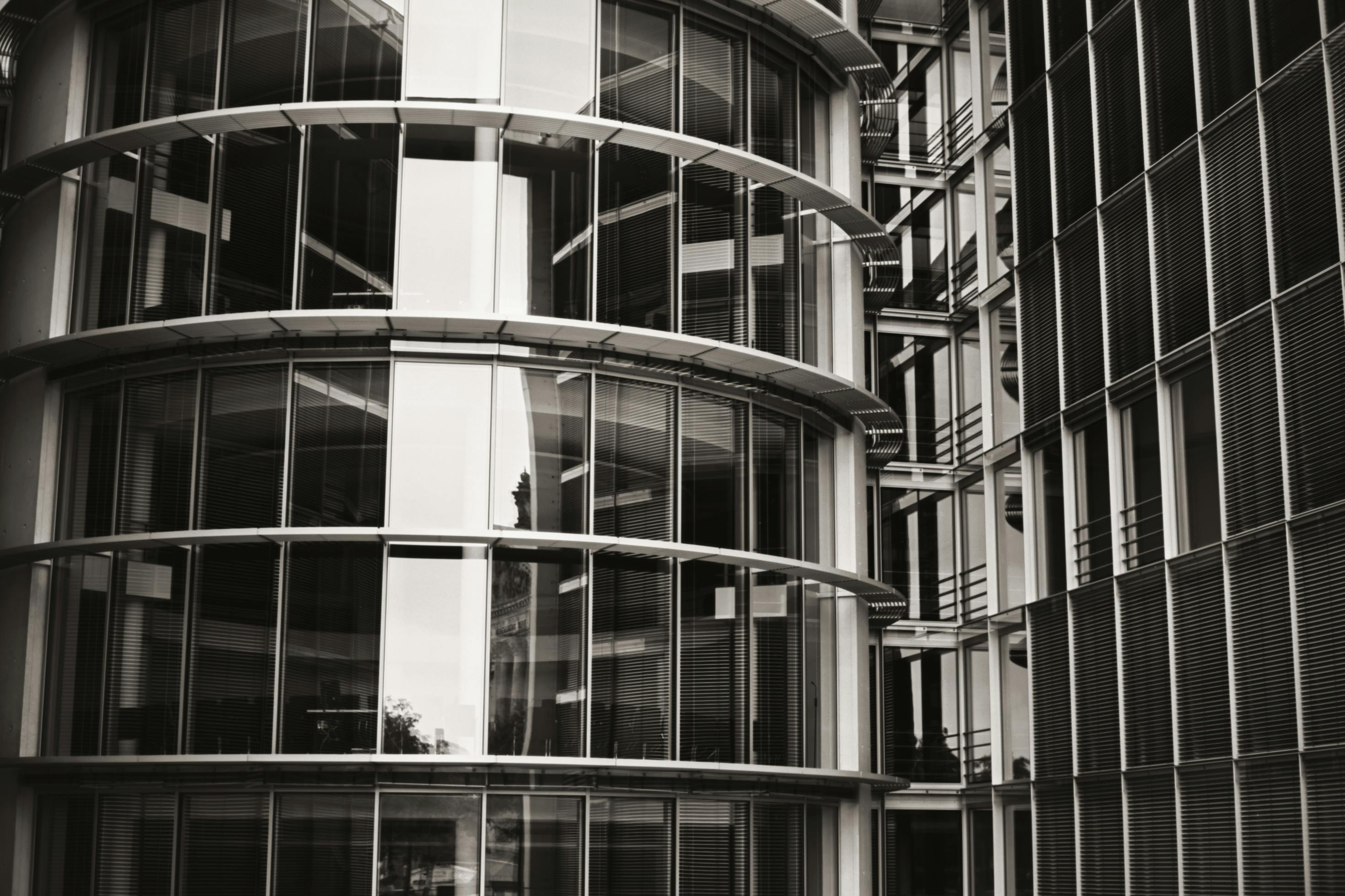 Free Close-up view of a modern architectural building facade with glass and steel structure in Berlin. Stock Photo