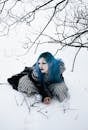Gothic Woman with Blue Hair in Snowy Forest