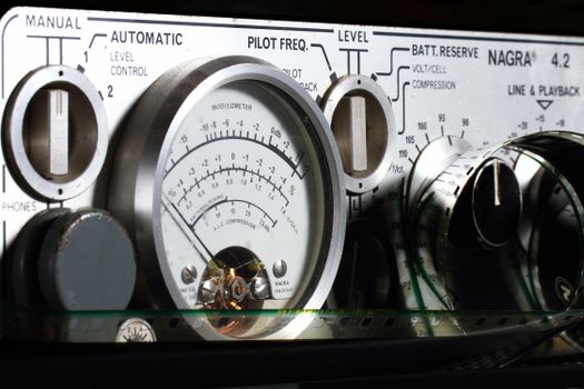 Detailed view of a Nagra 4.2 audio recorder control panel, highlighting gauges and dials.