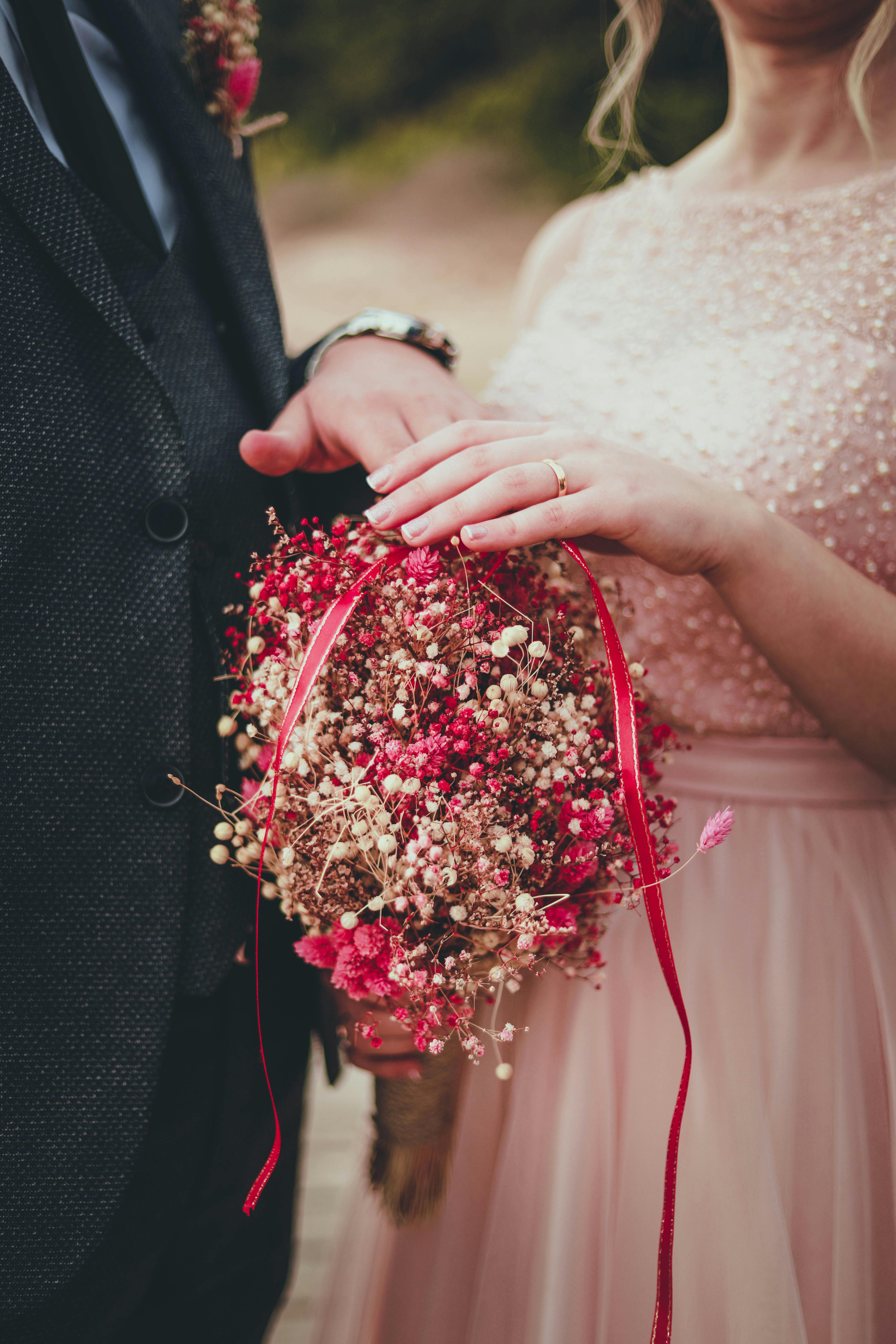 woman holding red and pink bouquet