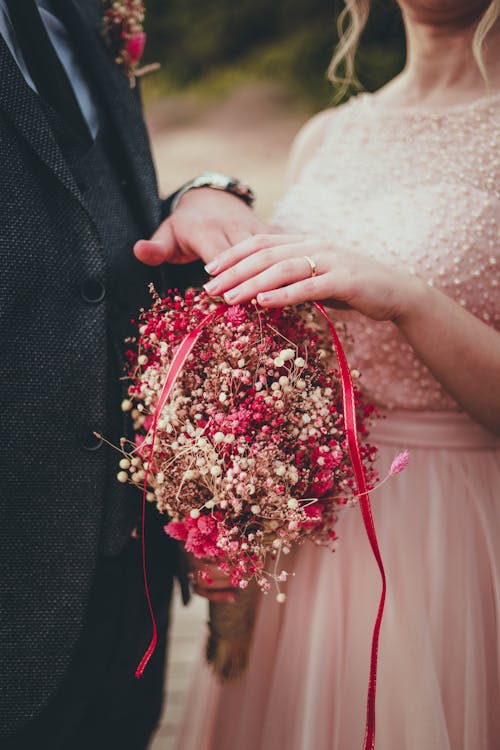 女人抱着红色和粉红色的花束
