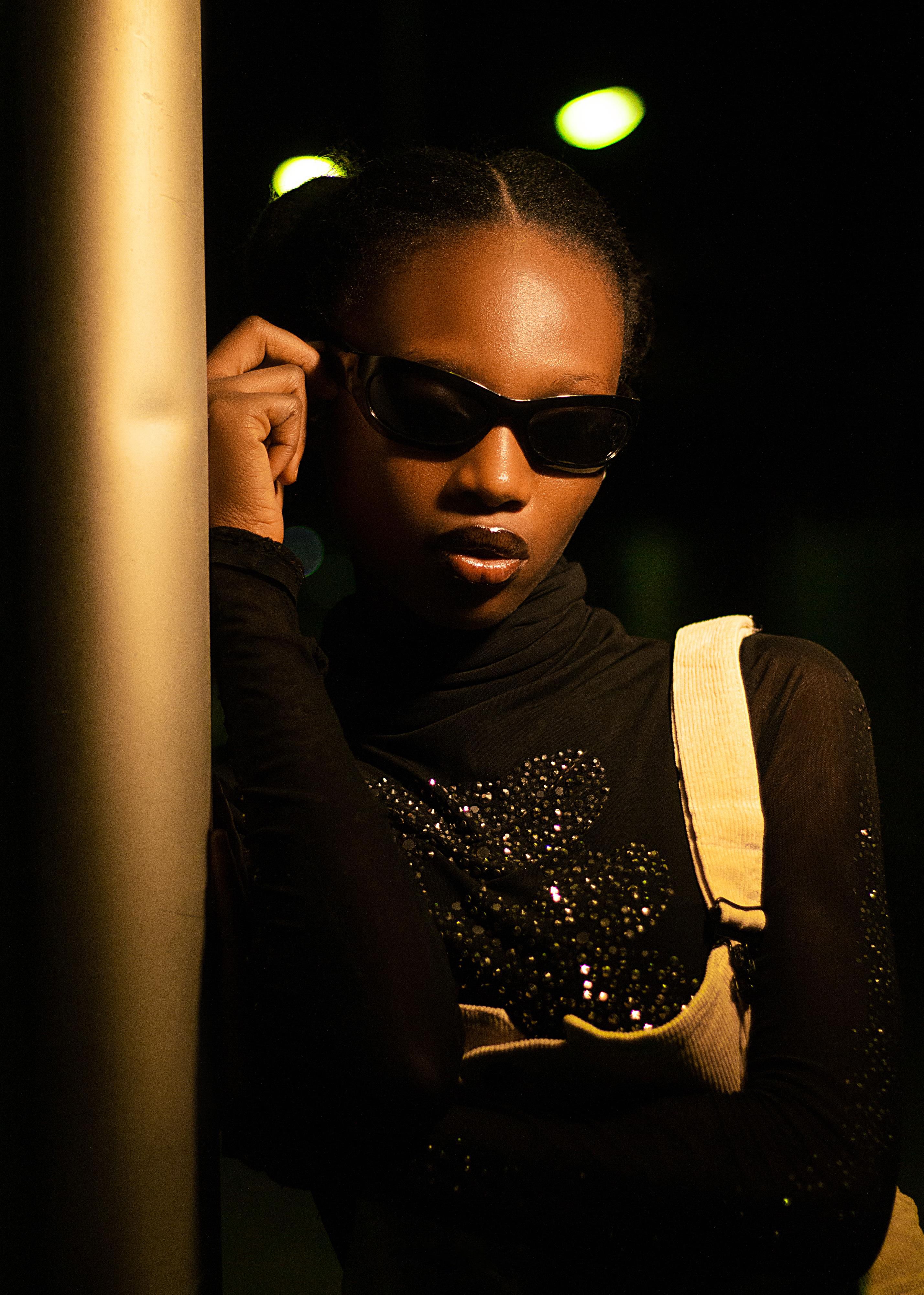 Stylish Young Woman Posing Outdoors at Night · Free Stock Photo