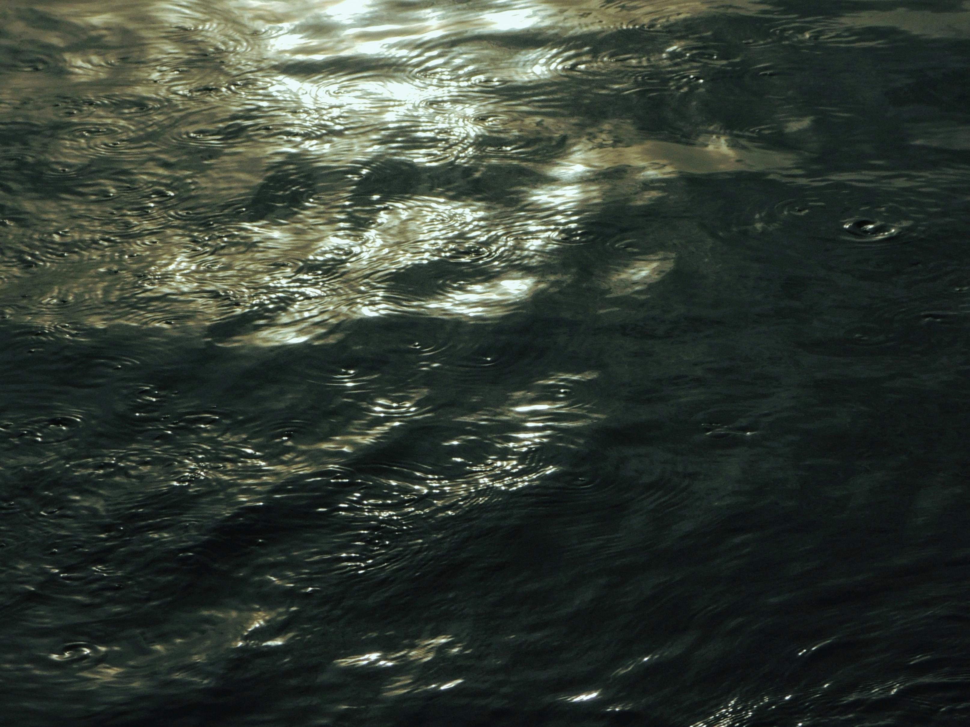 Free Reflective water surface capturing serene ripples and light in Banyuwangi, Indonesia. Stock Photo