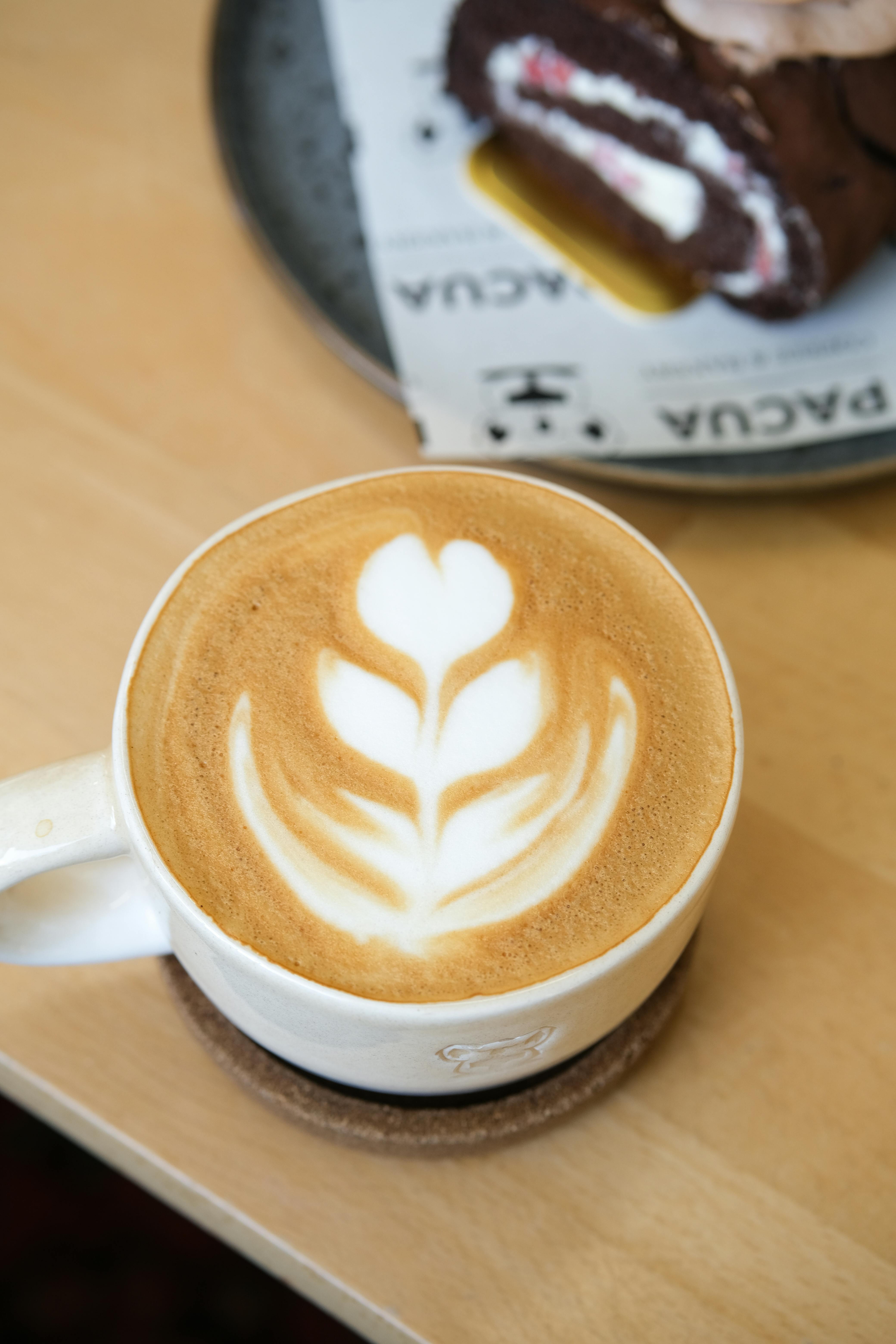 Latte Art and Chocolate Dessert on Wooden Table