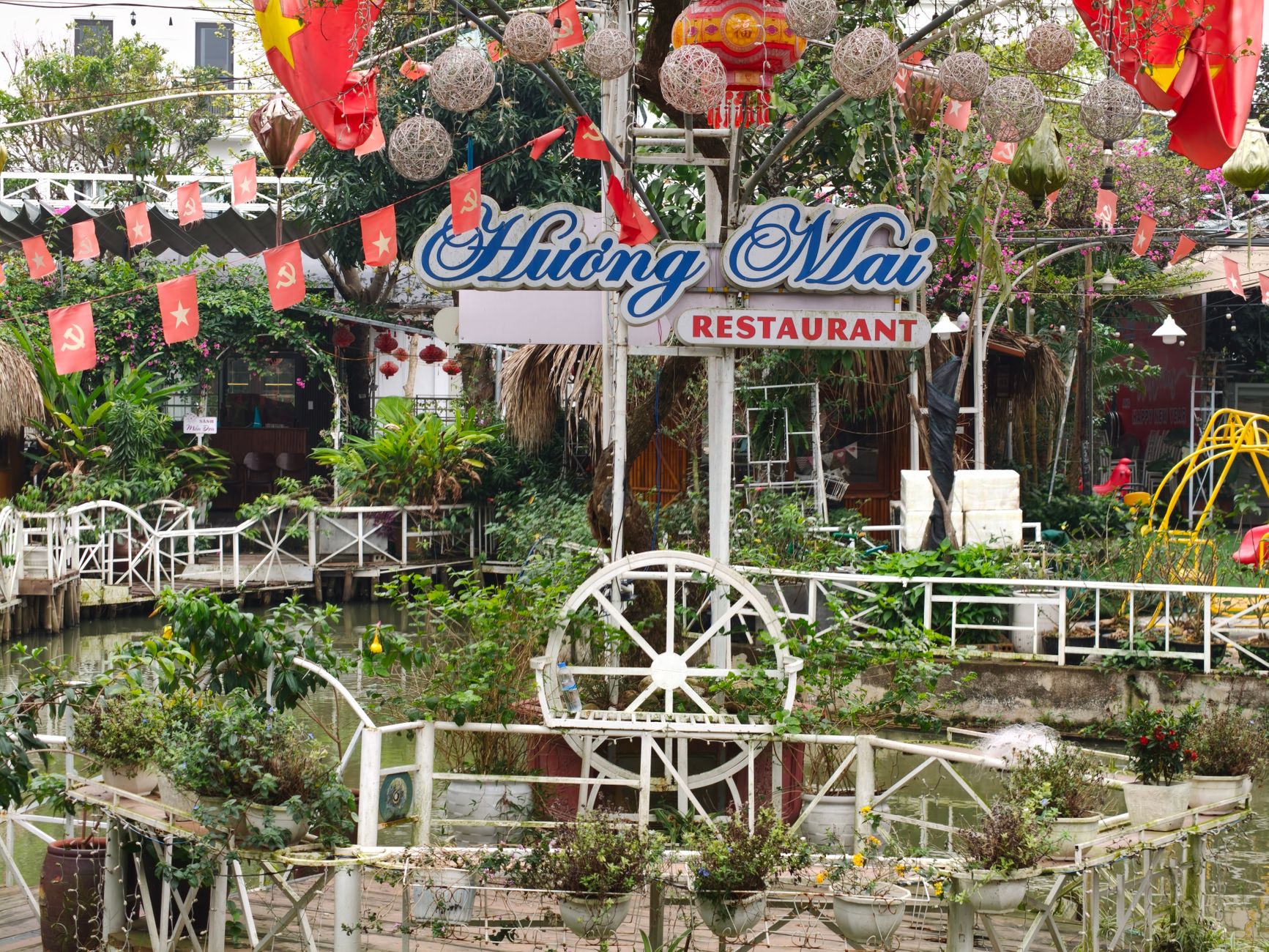 Beautiful outdoor garden area at Huong Mai Restaurant with festive decorations.