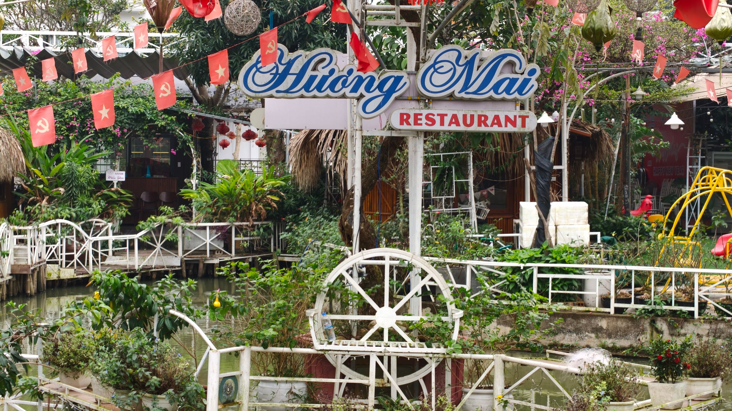 Beautiful outdoor garden area at Huong Mai Restaurant with festive decorations.