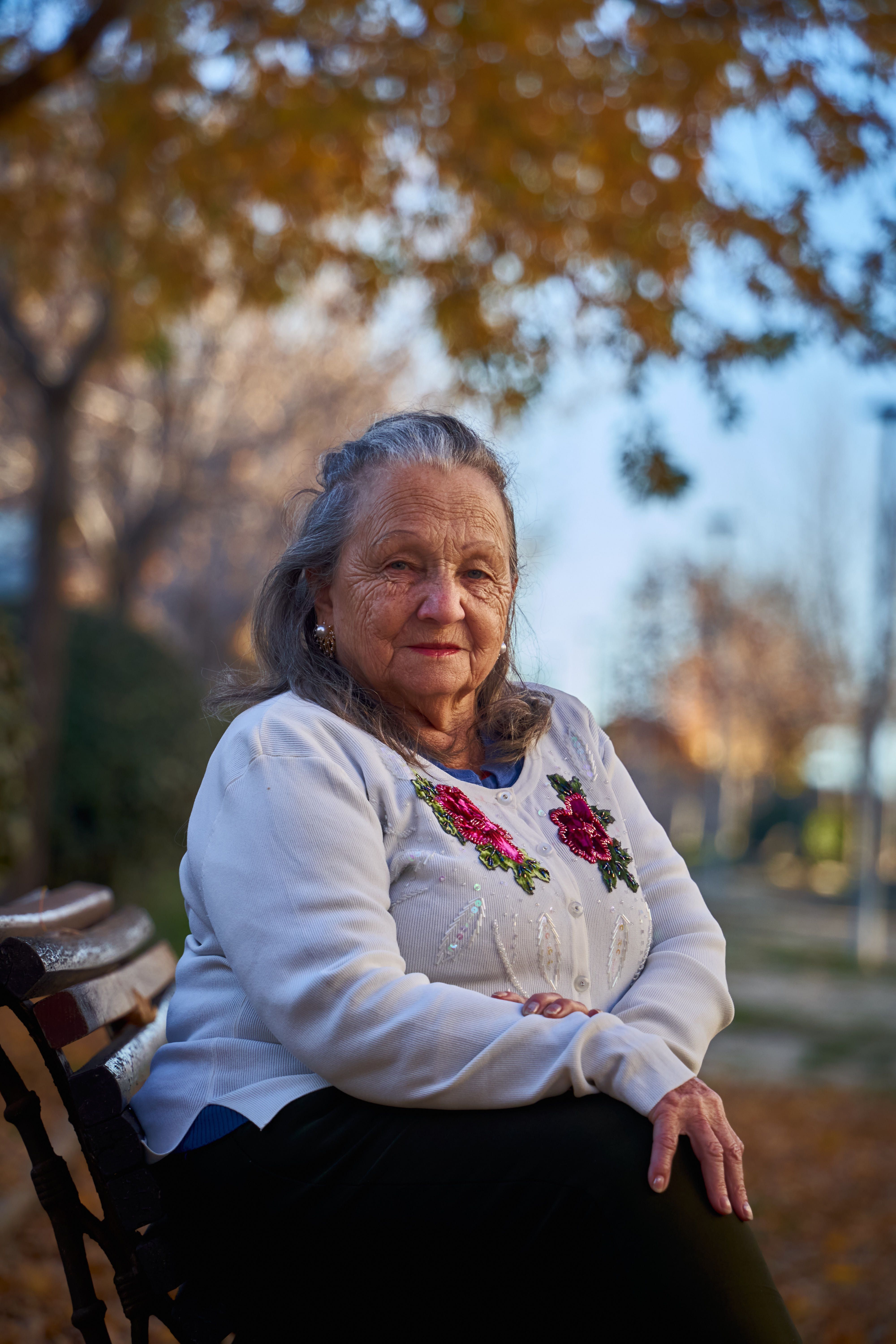 Fotomural Retrato de una mujer mayor sentada en un banco del parque en San Sebastián de los Reyes, España.
