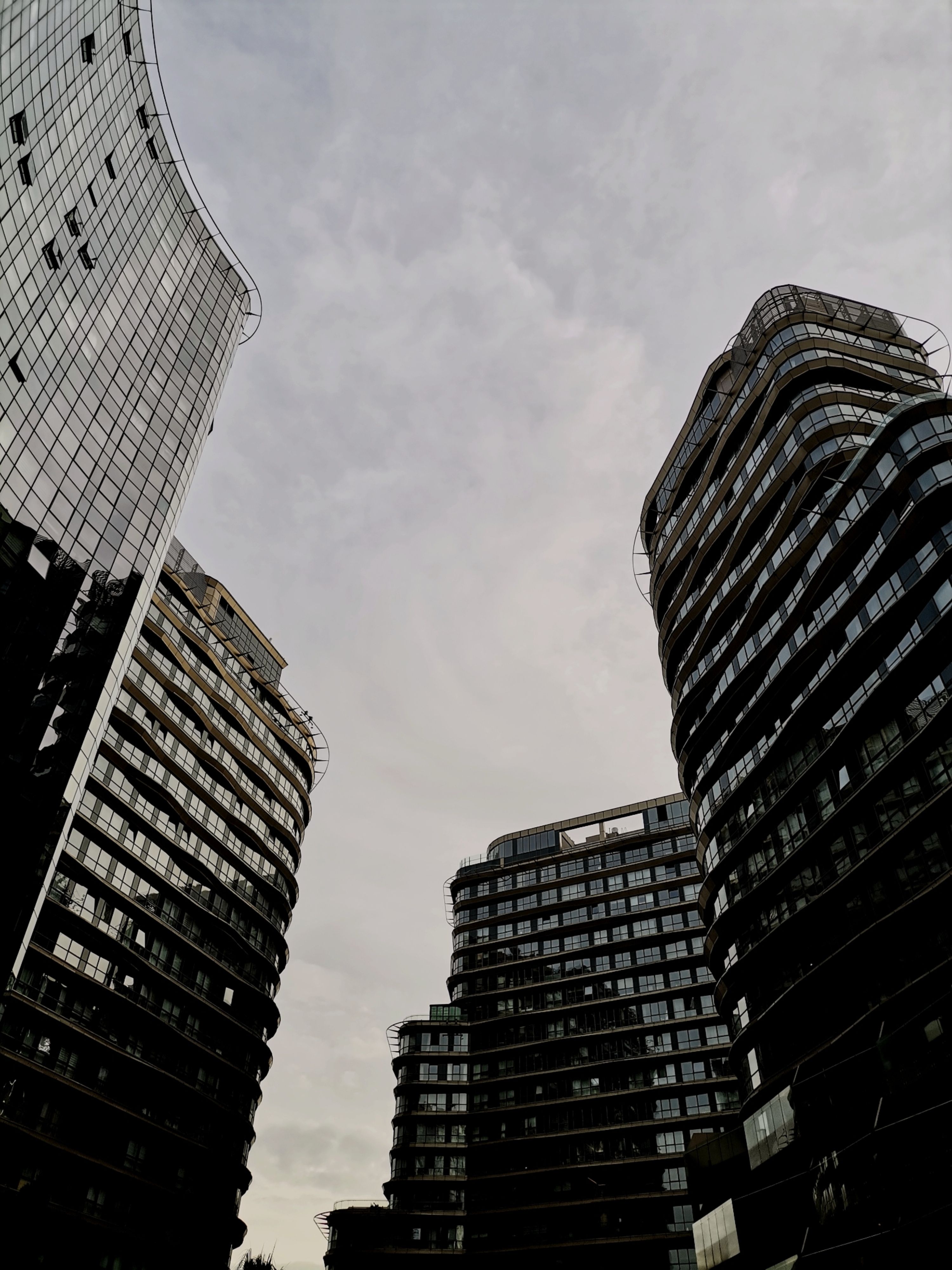Modern Architectural Skyscrapers Under Cloudy Sky · Free Stock Photo