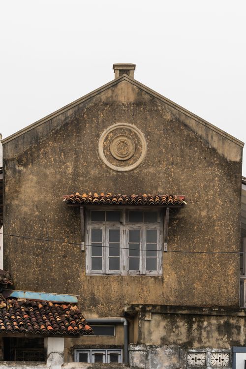 Free Deteriorating historic building facade with vintage design and European-style architecture. Stock Photo