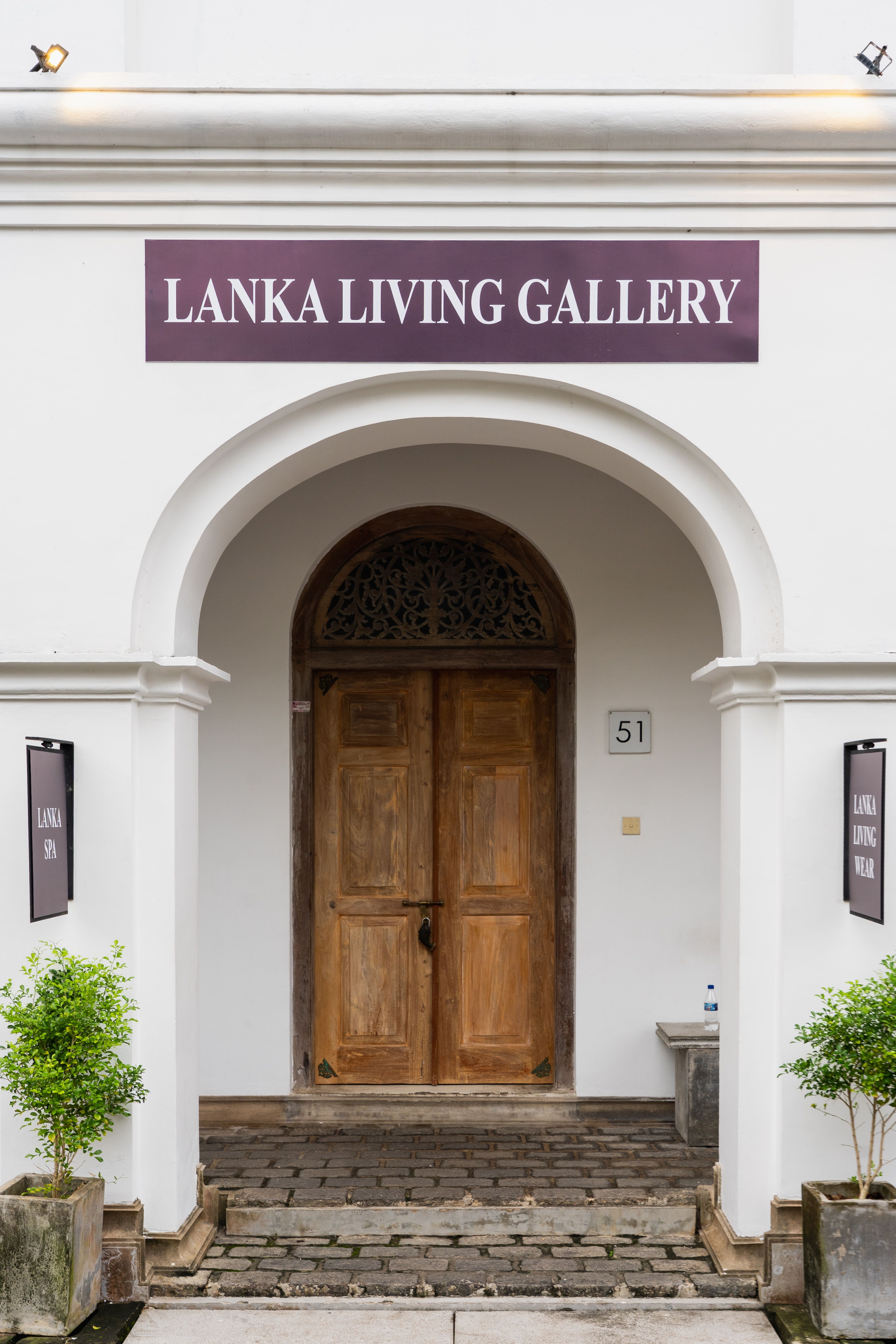Front archway view of Lanka Living Gallery entrance with wooden doors.