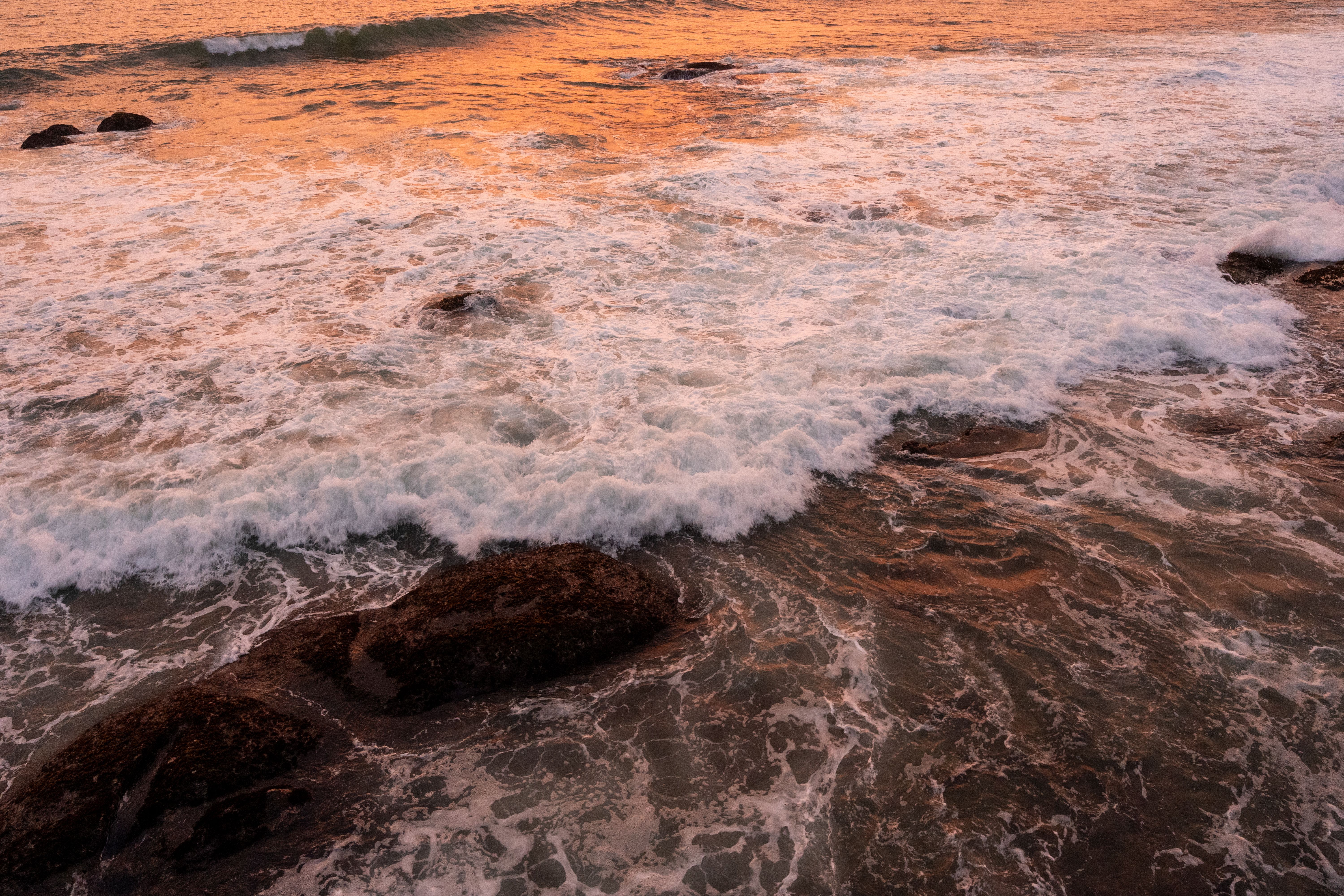 Vibrant Sunset Ocean Waves on Rocky Shore · Free Stock Photo