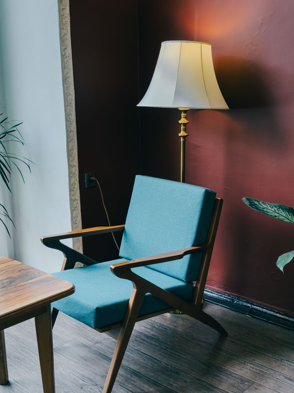 A serene modern interior with a teal armchair, wooden table, and floor lamp under soft light.. pexels, serene, modern