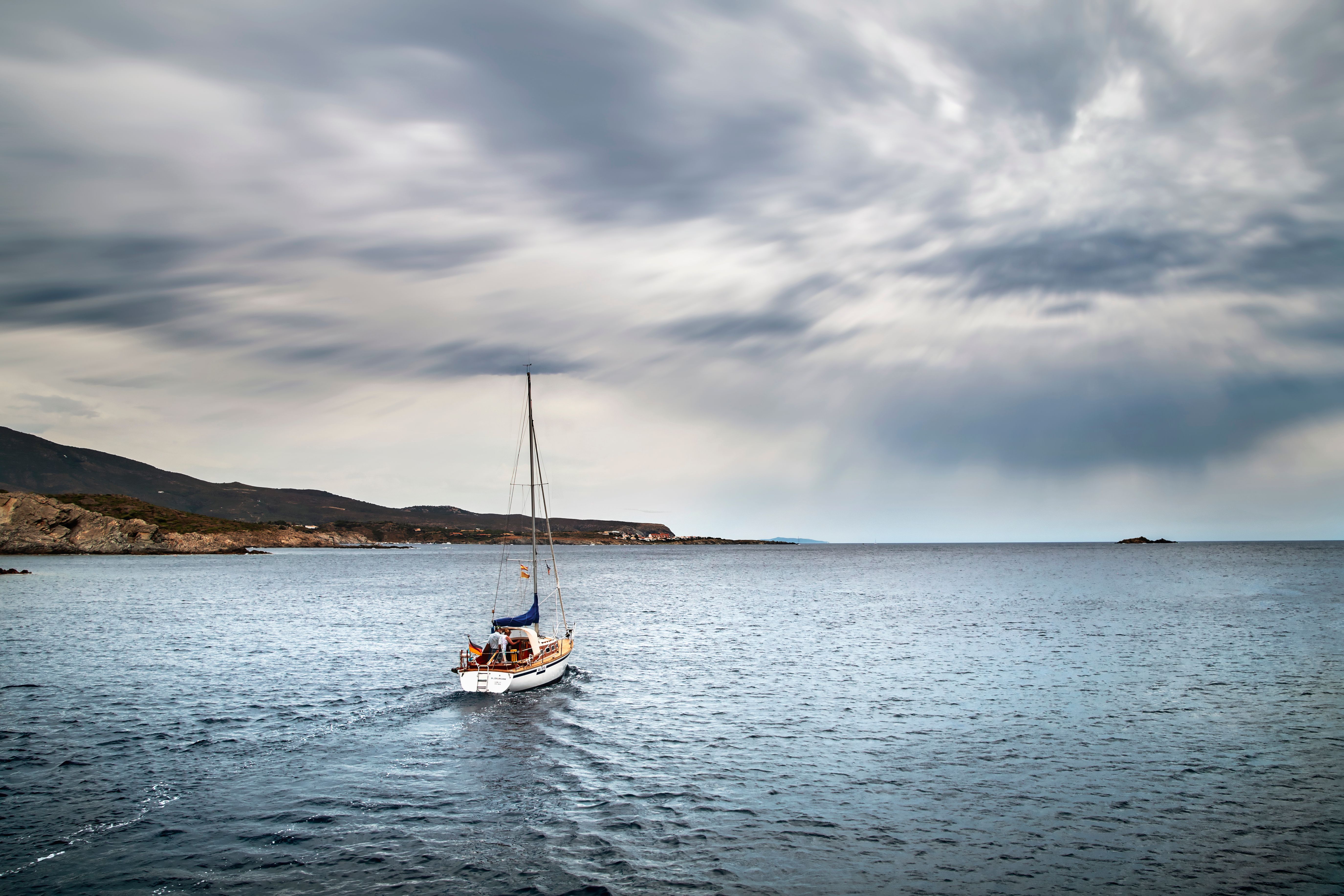 Sailing Boat on Open Sea under Cloudy Sky · Free Stock Photo