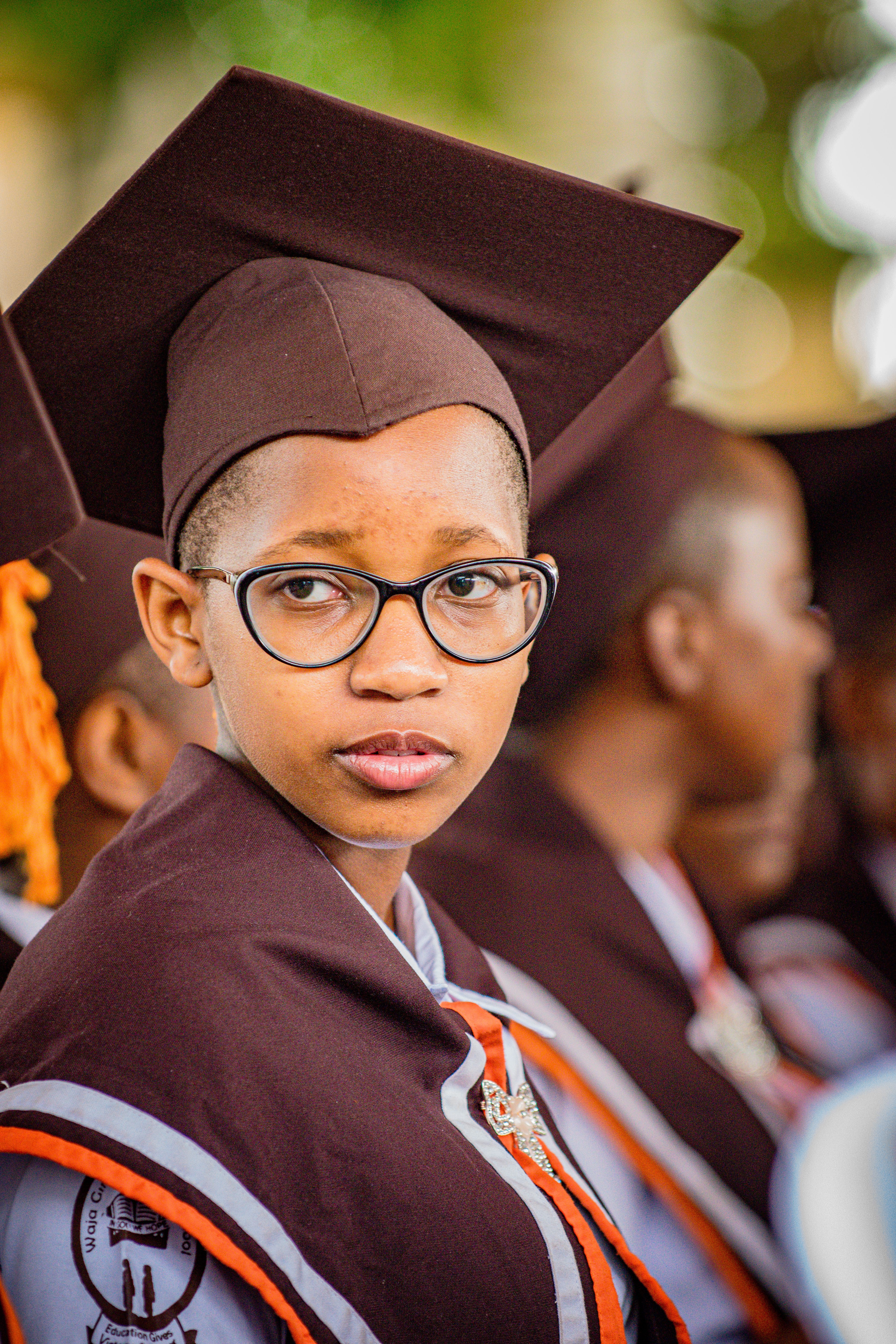 Young Graduate in Cap and Gown at Ceremony · Free Stock Photo