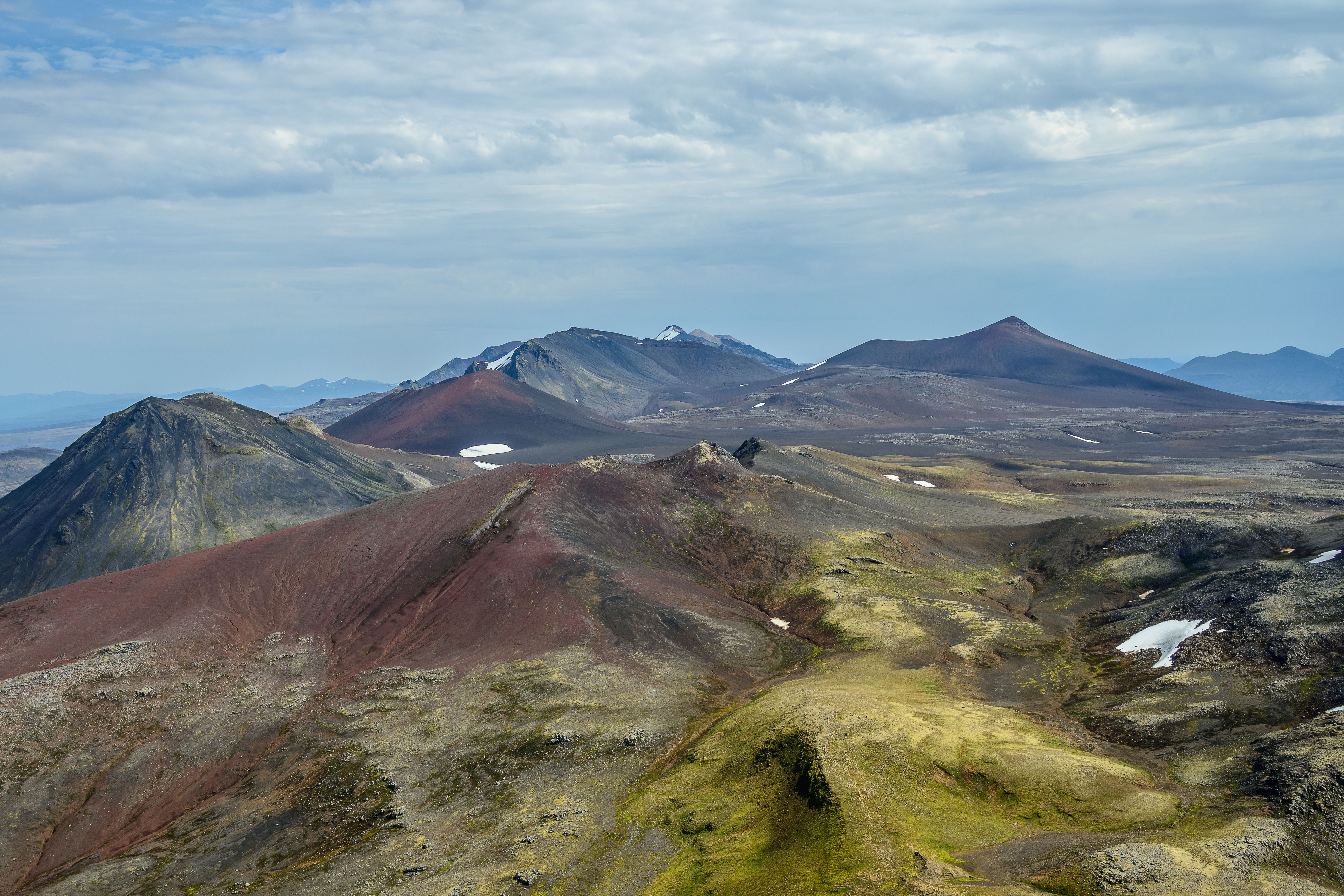 Unforgettable Landmarks from Above: Helicopter Tour with 3 Landings Review Review 2026 - Stunning aerial view of volcanic mountains with colorful peaks and rugged terrain in Iceland.