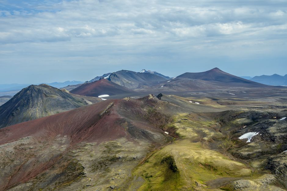 Unforgettable Landmarks from Above: Helicopter Tour with 3 Landings Review Review 2026 - Stunning aerial view of volcanic mountains with colorful peaks and rugged terrain in Iceland.